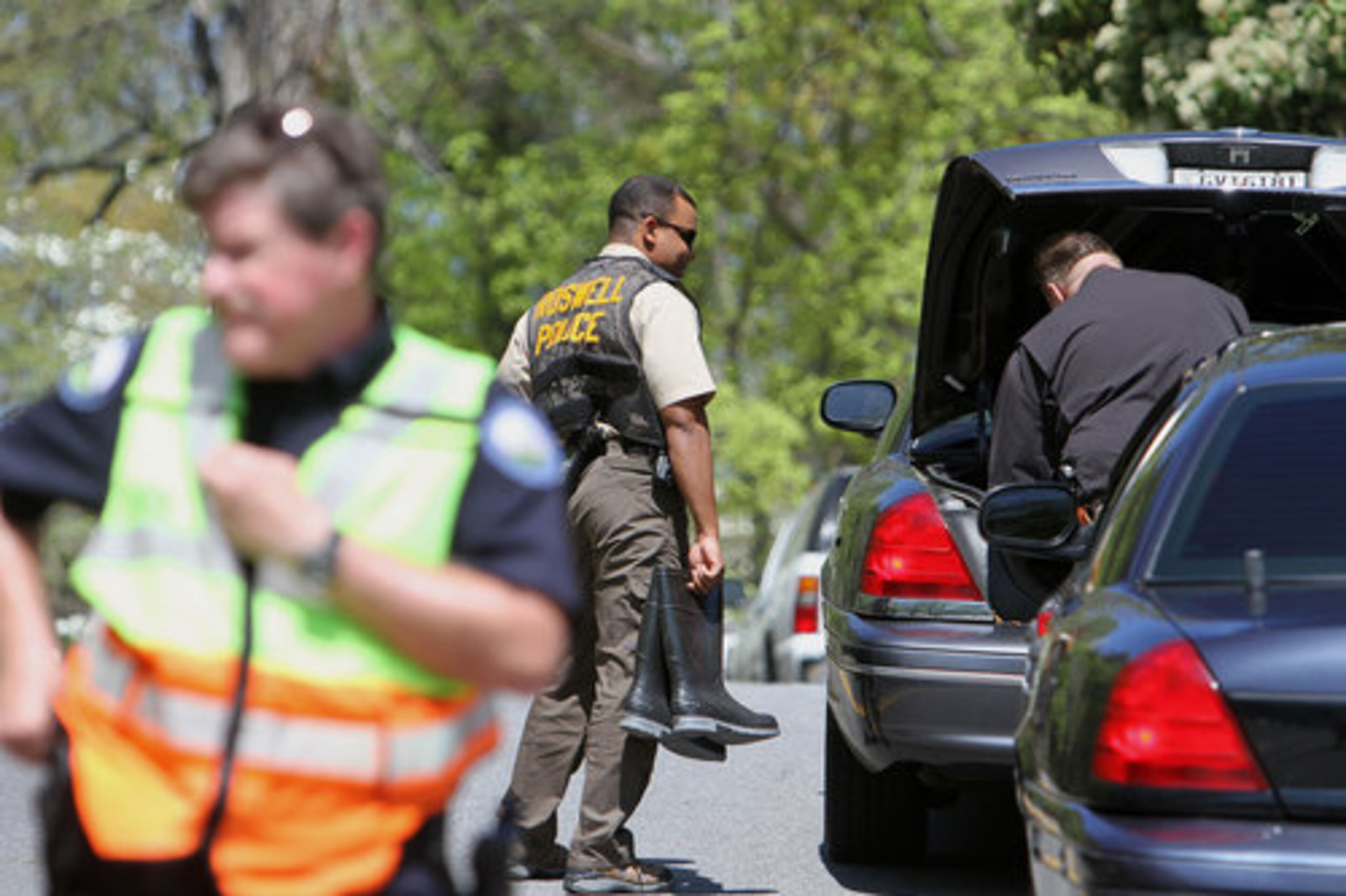 Officials on the scene of the explosion at Alpine Drive in Roswell, Monday, March 26, 2012.