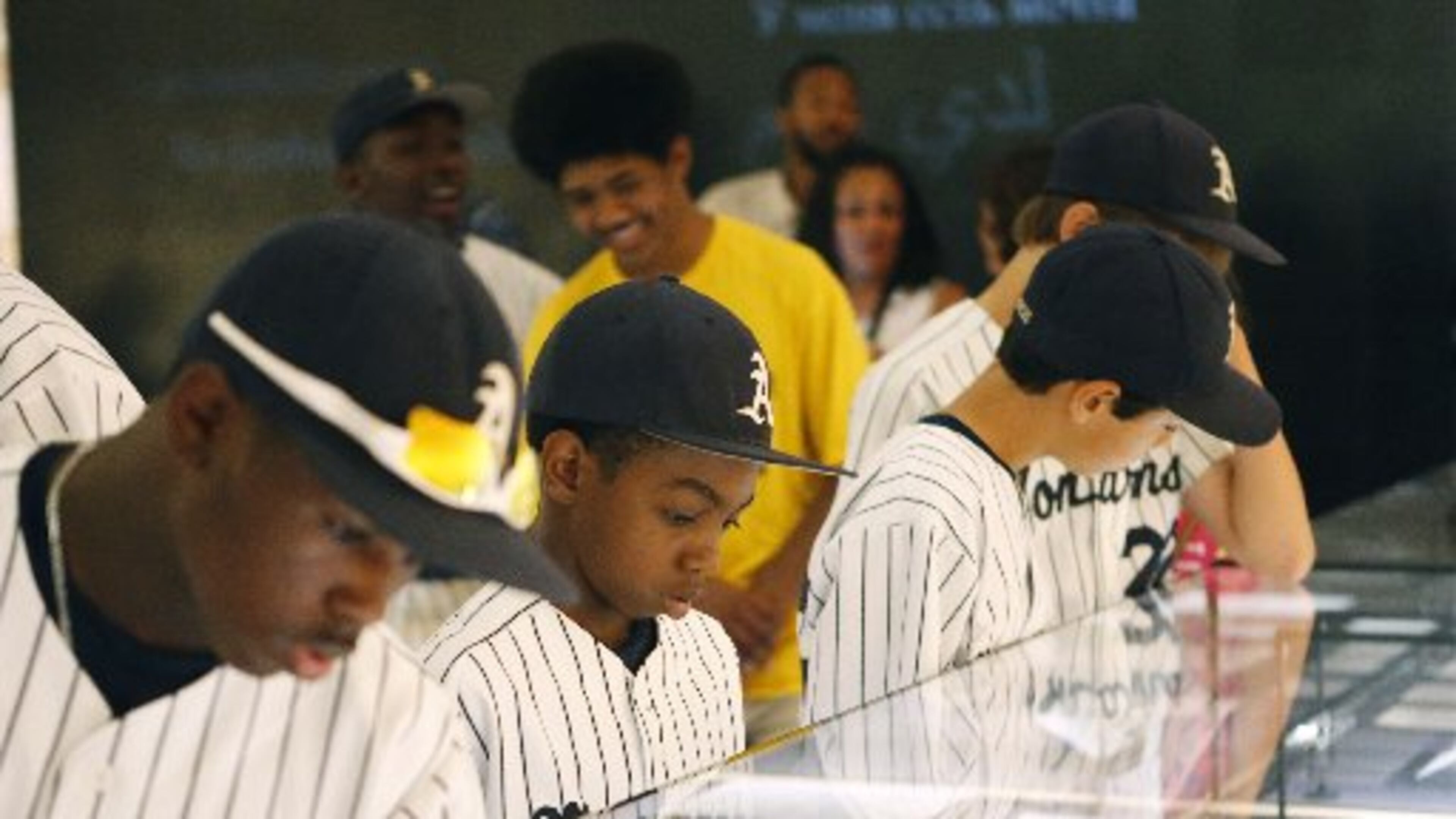 Jahli Hendricks (from left), Nasir Jackson and Jack Rice of the Philadelphia-based Anderson Monarchs look over some of the King papers at the National Center for Civil and Human Rights. The center marked its first anniversary last week. BOB ANDRES / BANDRES@AJC.COM