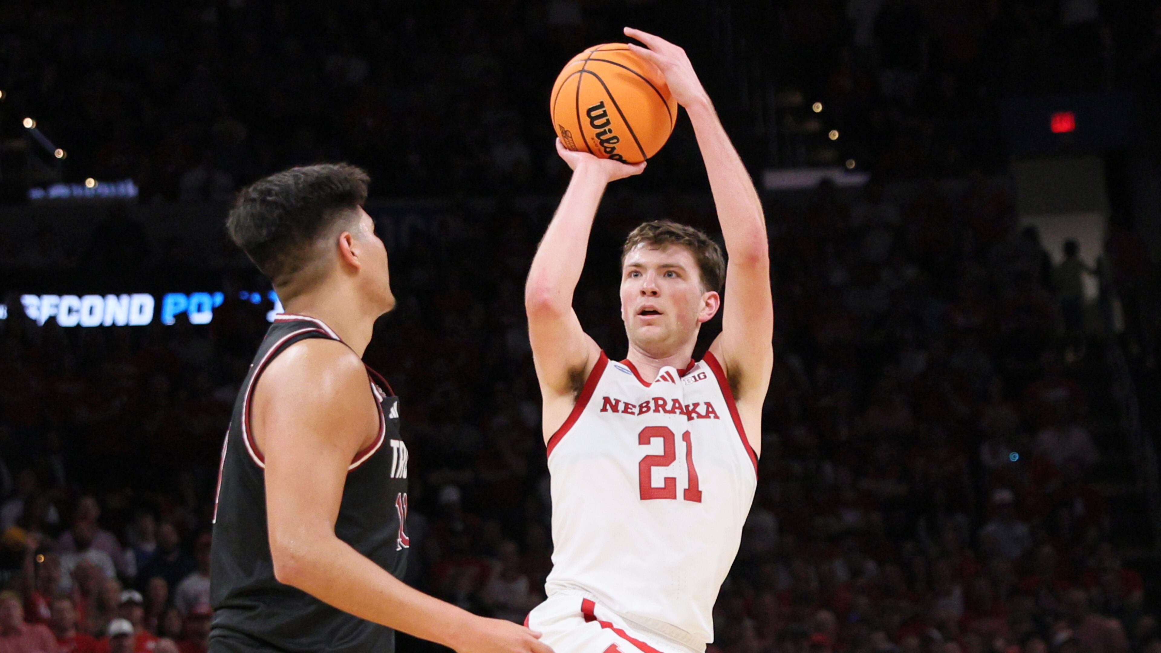 Nebraska forward Pryce Sandfort (21) looks to shoot over Troy forward Victor Valdes, left, during the first half in the first round of the NCAA college basketball tournament, Thursday, March 19, 2026, in Oklahoma City. (AP Photo/Nate Billings)