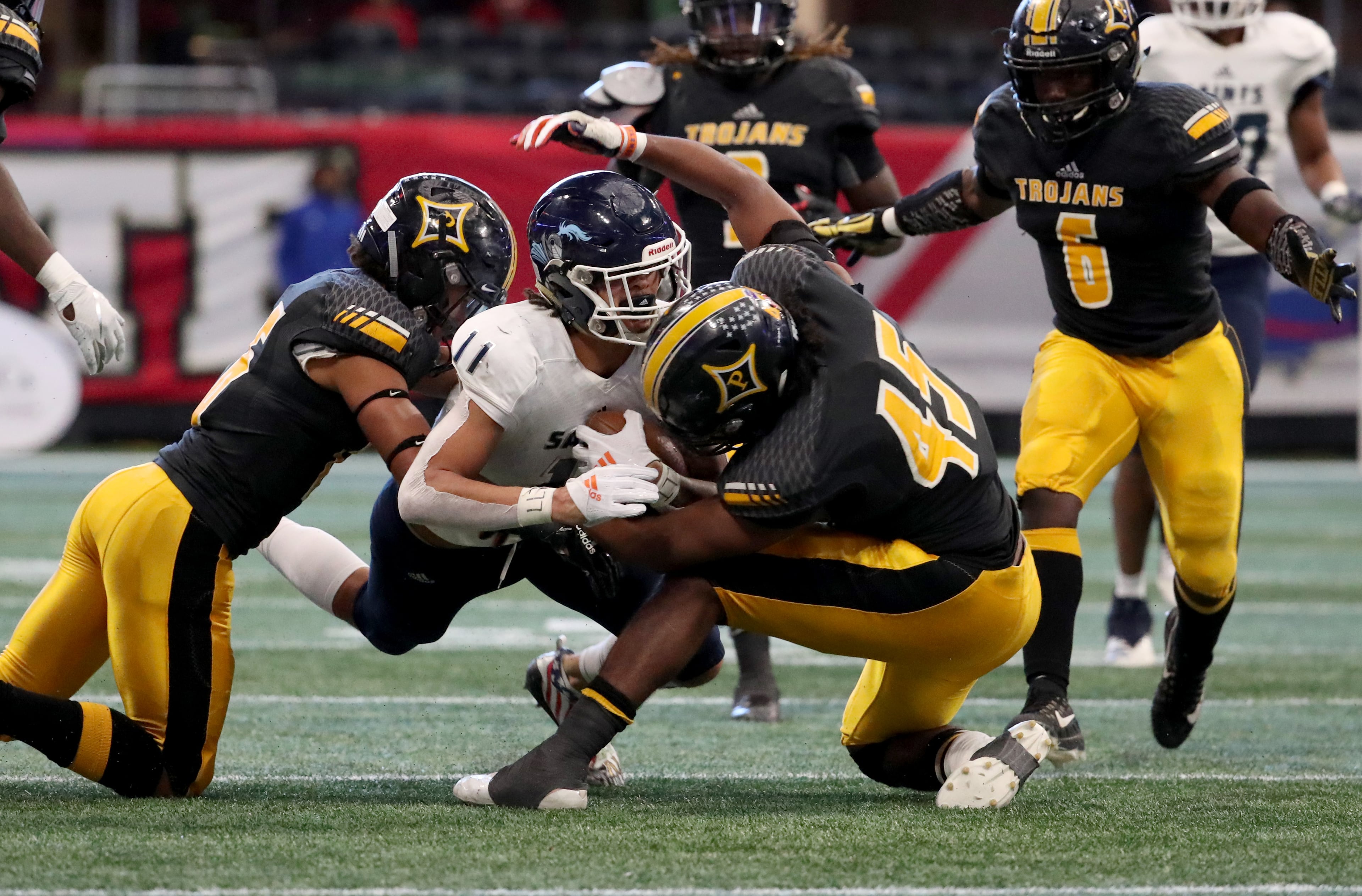 Cedar Grove wide receiver Jadon Haselwood (11) is tackled by Peach County Daelan Smith, left, and Sergio Allen (45) after a catch by Haselwood in the first half of the Class AAA State Championship at Mercedes-Benz Stadium, Tuesday, December 11, 2018, in Atlanta. (Jason Getz/Special to the AJC)
