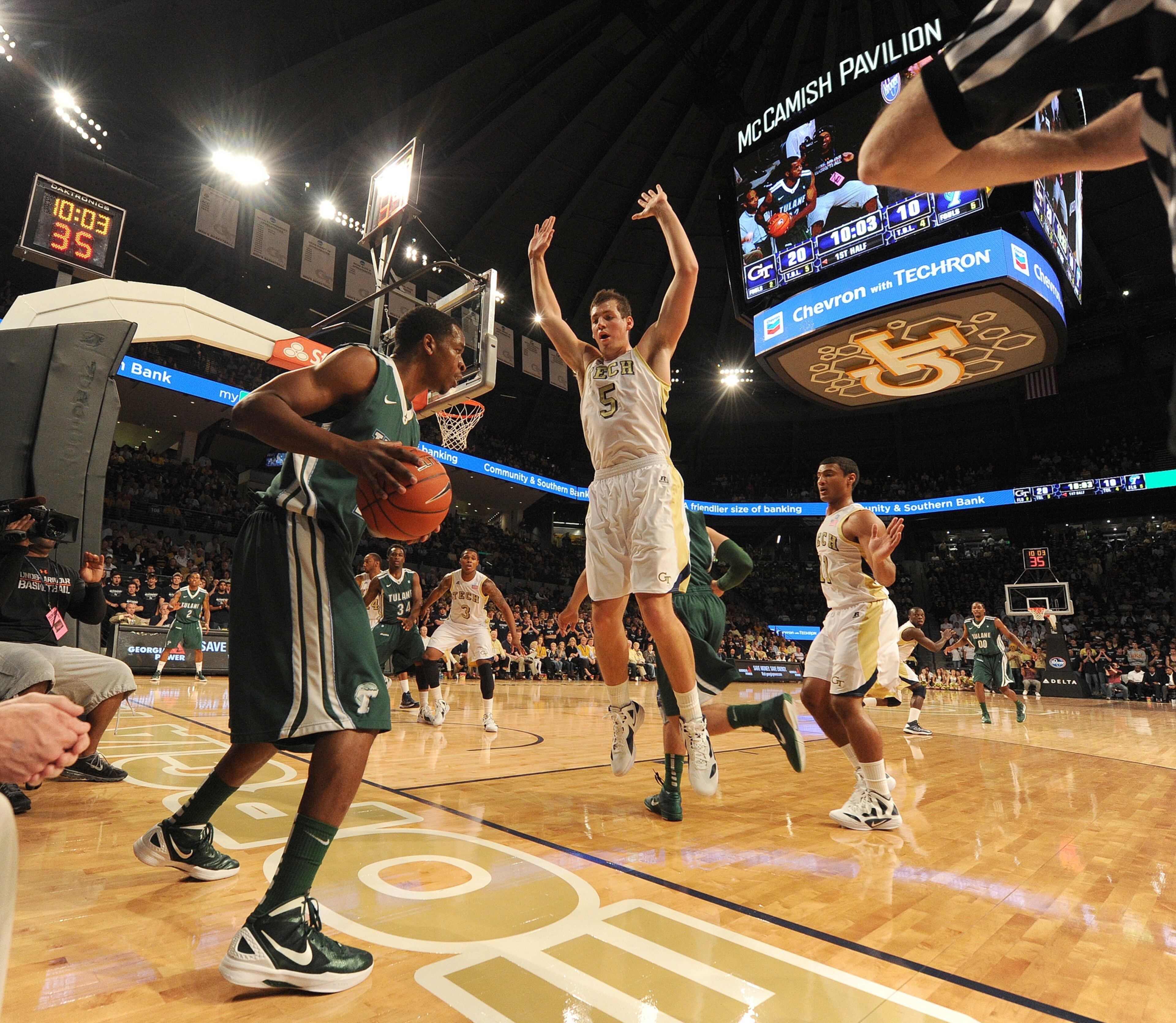 Tech's Daniel Miller (5) jumps up and down as he tries to block the passing lane on an inbound attempt.