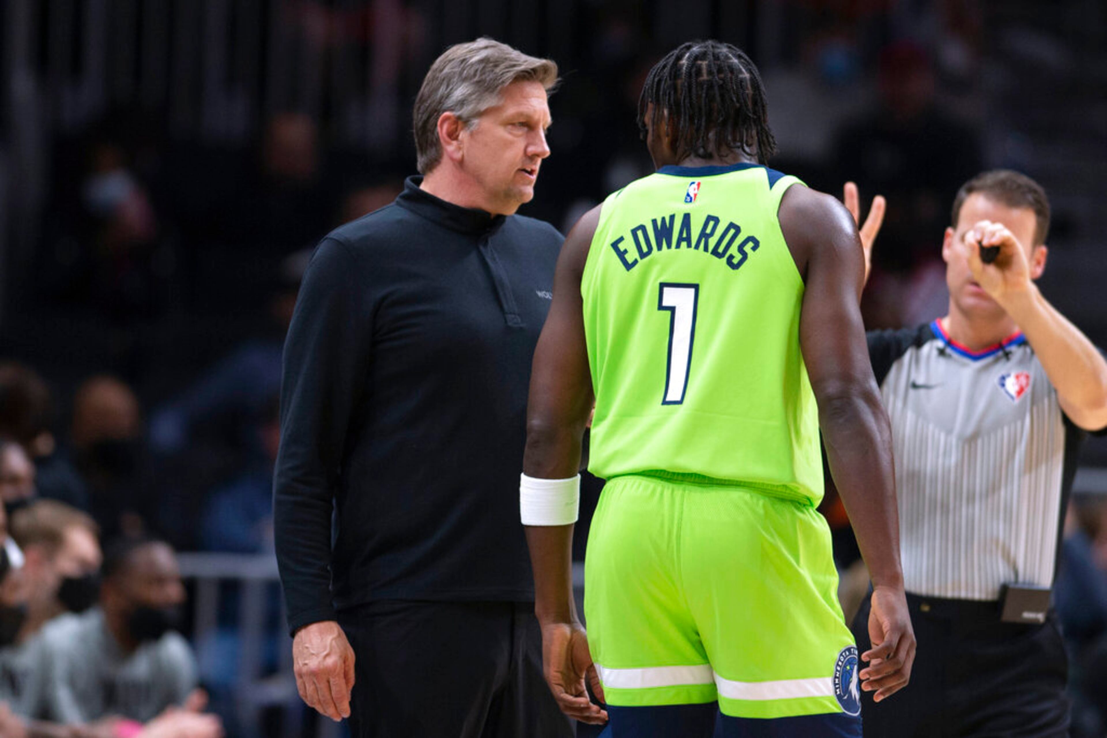 Minnesota Timberwolves coach Chris Finch talks with forward Anthony Edwards (1) during the first half of the team's NBA basketball game against the Atlanta Hawks Wednesday, Jan. 19, 2022, in Atlanta. (AP Photo/Hakim Wright Sr.)