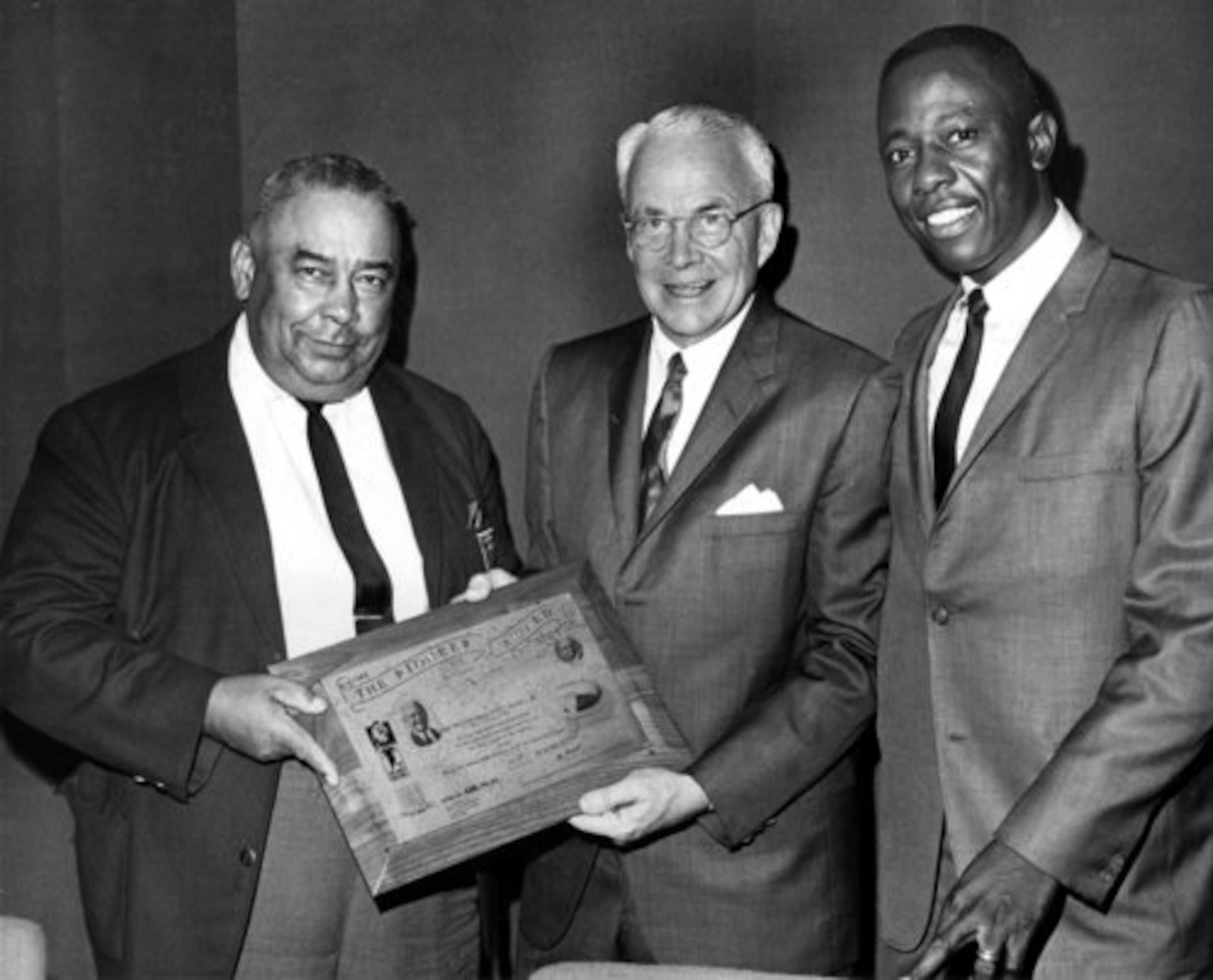 But when the major leagues arrived in Atlanta with the Braves' relocation from Milwaukee, Aaron was quickly treated as a local sporting hero. After leading the National League with 39 home runs in 1967, he visits with former mayor Ivan Allen (center) and Al Thompson at the Atlanta-based 100 Percent Wrong Club banquet.