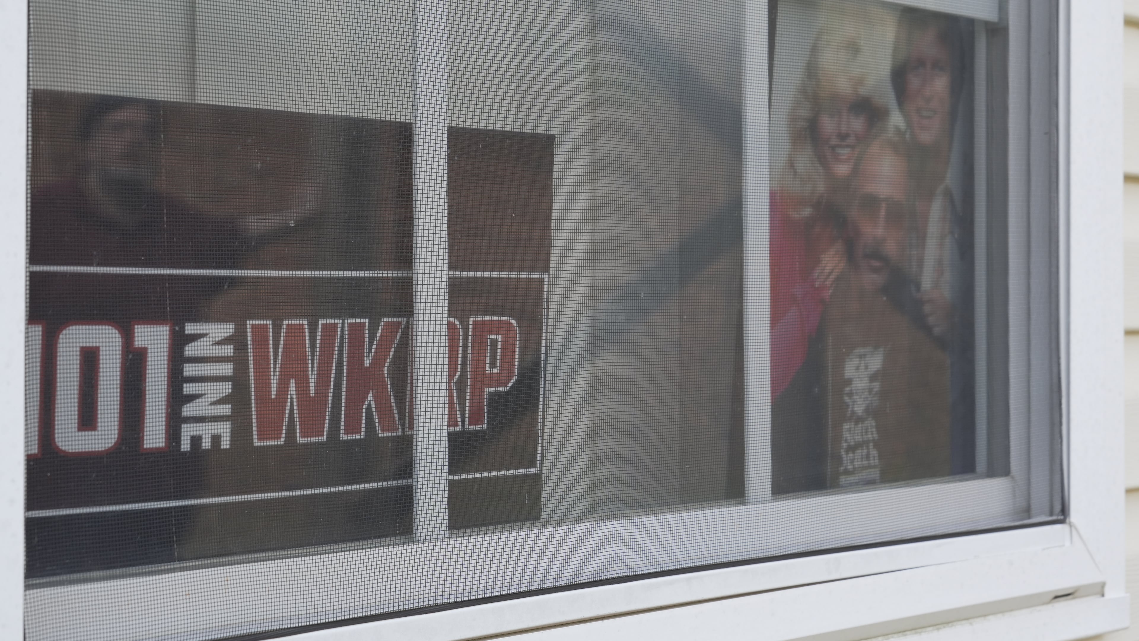 FILE - A photo of the cast members of the sitcom "WKRP in Cincinnati" sits in a window at the home of D.P. McIntire in Raleigh, N.C., on April 2, 2026. (AP Photo/Allen G. Breed, file)