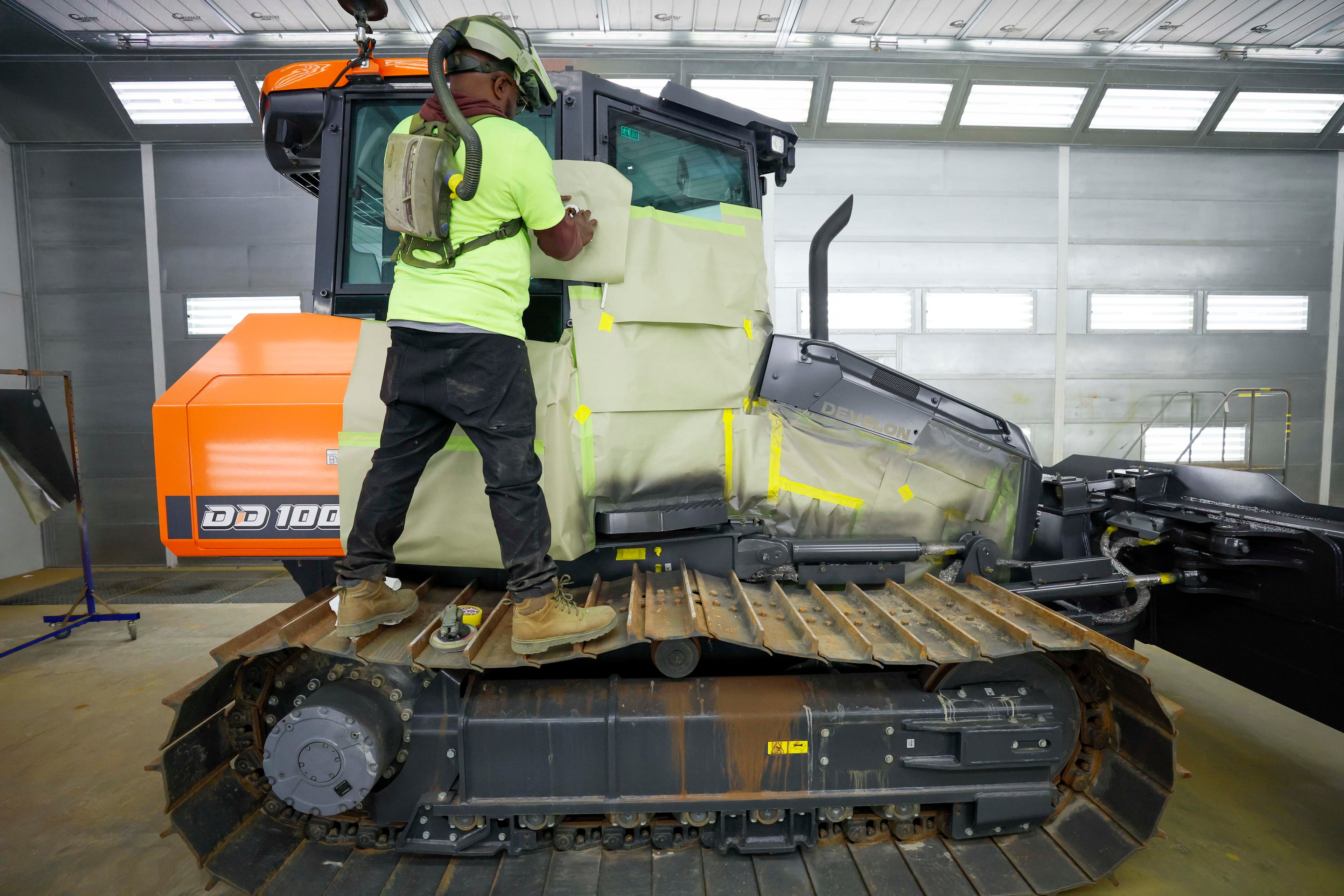 A worker masks a machine in a paint room at one of the assembly plants at a Georgia Port Authority facility in Brunswick, Ga., on Wednesday, Jan. 14, 2026. (Miguel Martinez/ AJC)