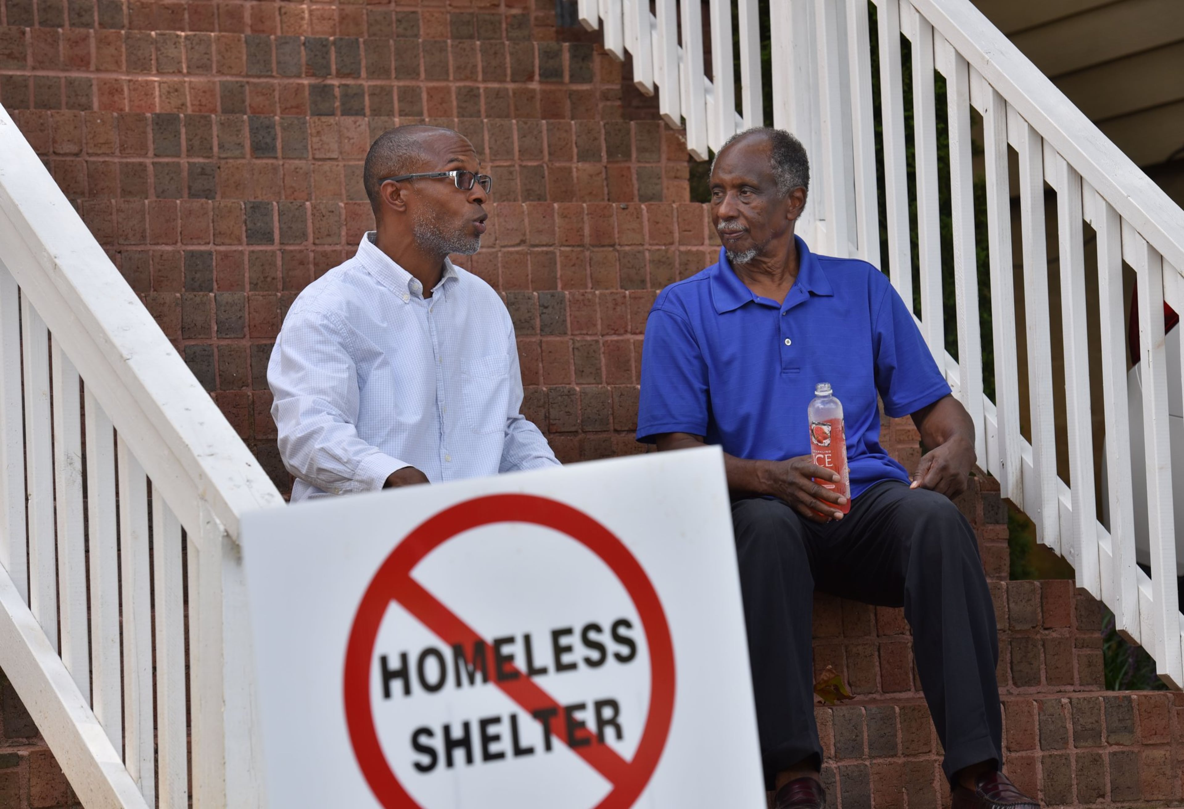 In this August 2016 photo, Devon Holloway (left) and former state Rep. Douglas Dean talk outside Holloway’s home in the Pittsburgh neighborhood of Atlanta. Holloway co-founded PittsburghAtl Homeowners United, a group of relatively new Pittsburgh residents. Dean, meanwhile, heads the Pittsburgh Neighborhood Association that consists mostly of longtime residents. HYOSUB SHIN / HSHIN@AJC.COM