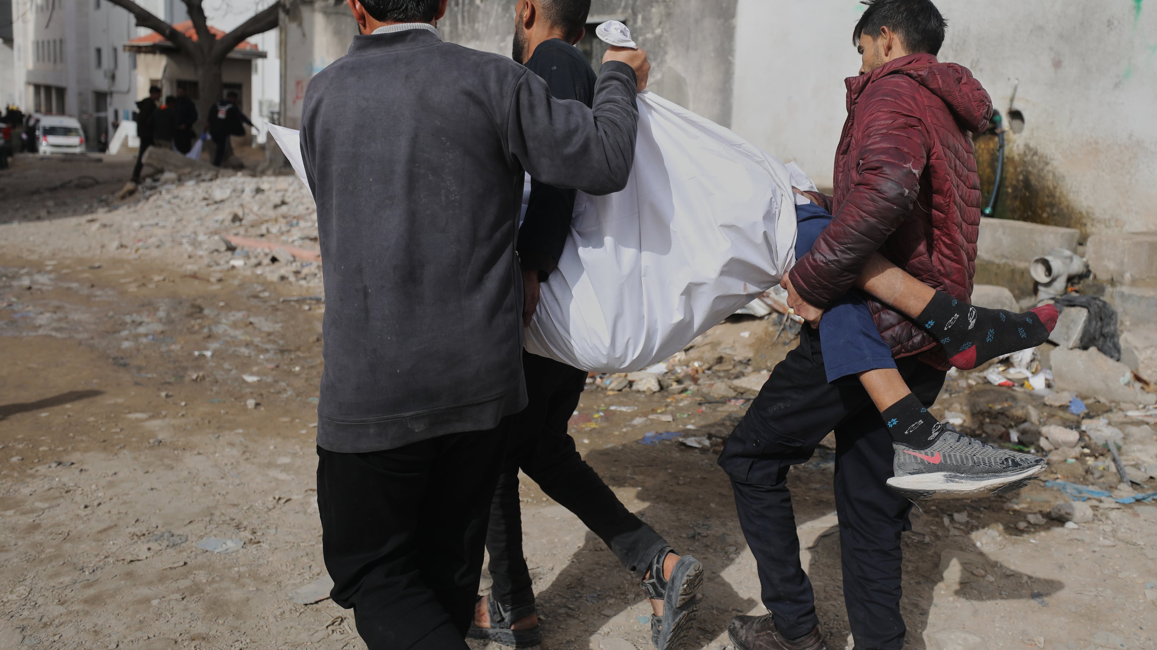 Palestinians carry the body of Mohammad Zawara, 15, who was killed in an Israeli strike, according to health officials, as they arrive at Shifa Hospital, Gaza City, Saturday, Jan. 24, 2026. (AP Photo/Yousef Al Zanoun)