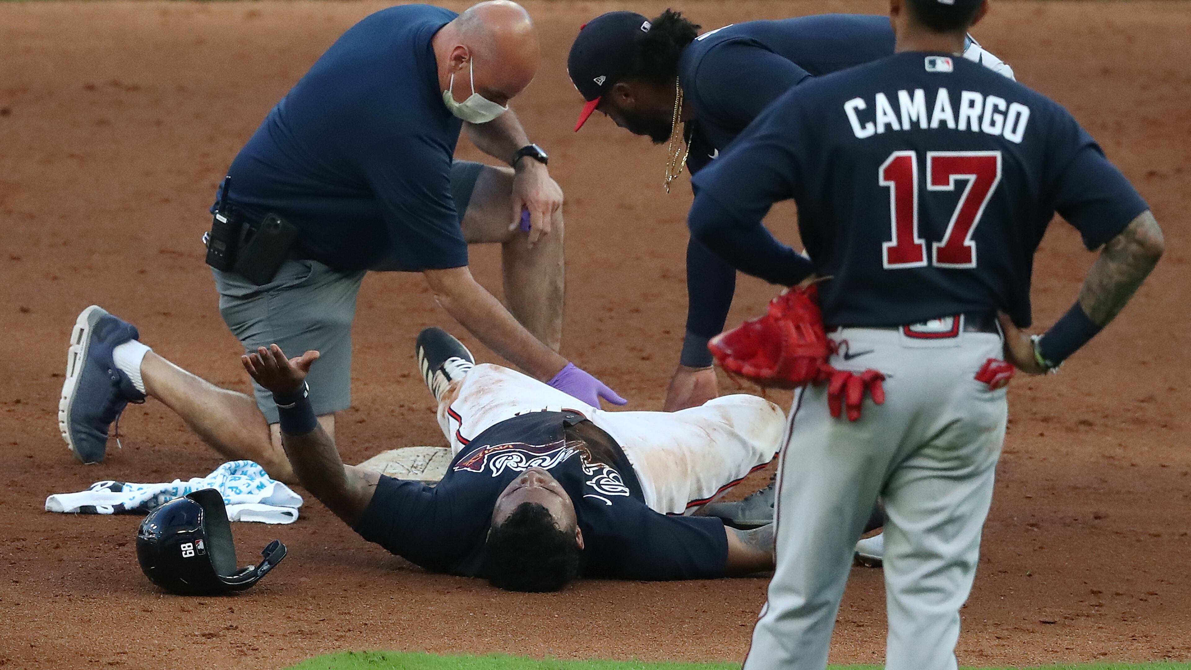 Braves outfielder Cristian Pache lays on the ground after suffering an injury on Monday, July 13, 2020 in Atlanta. (Curtis Compton/Atlanta Journal-Constitution)