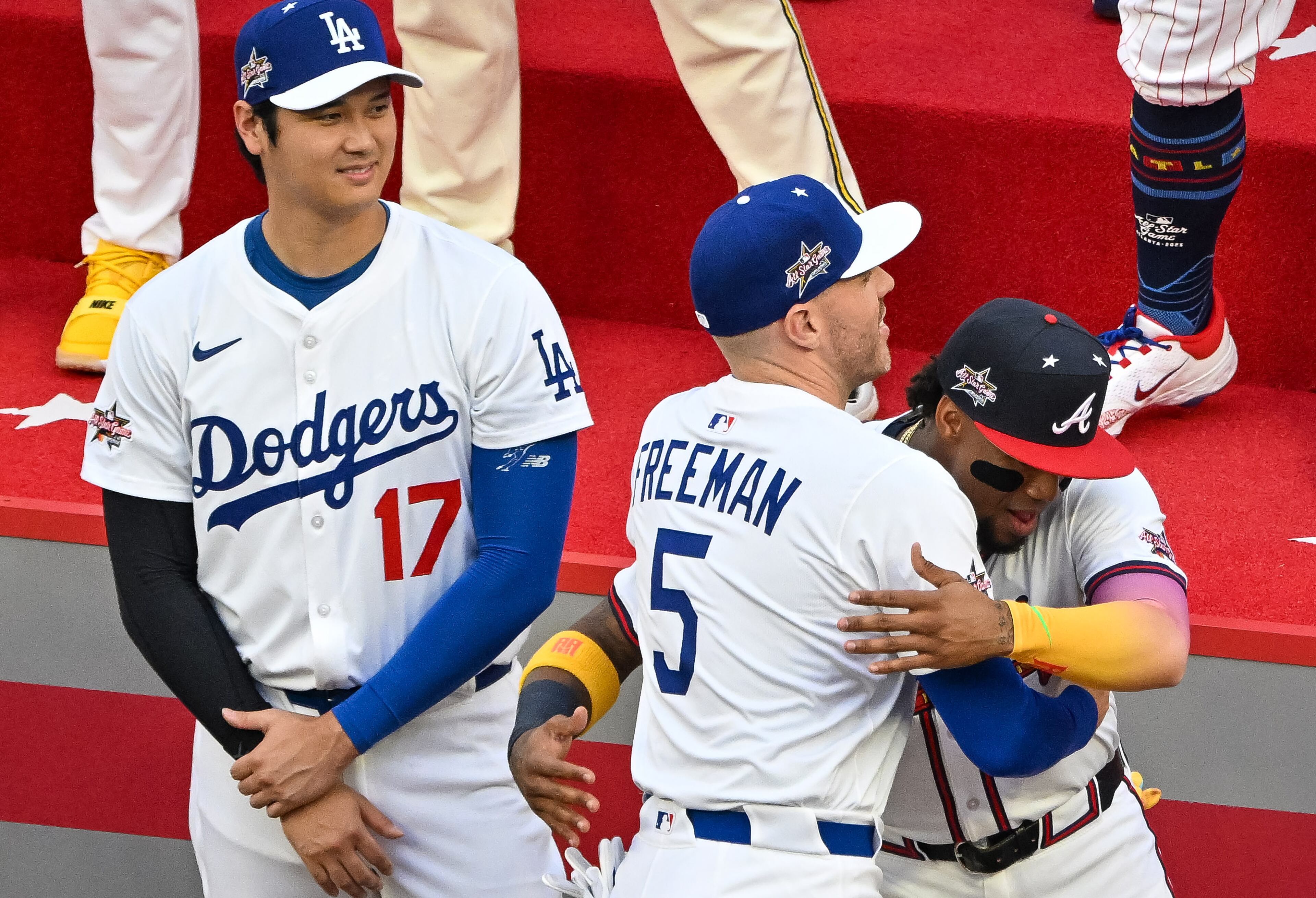 The National League's Freddie Freeman of the Los Angeles Dodgers greets former teammate Atlanta Braves' Ronald Acuña Jr. before the MLB All-Star Game at Truist Park in Atlanta on Tuesday, July 15, 2025. (Hyosub Shin/AJC)