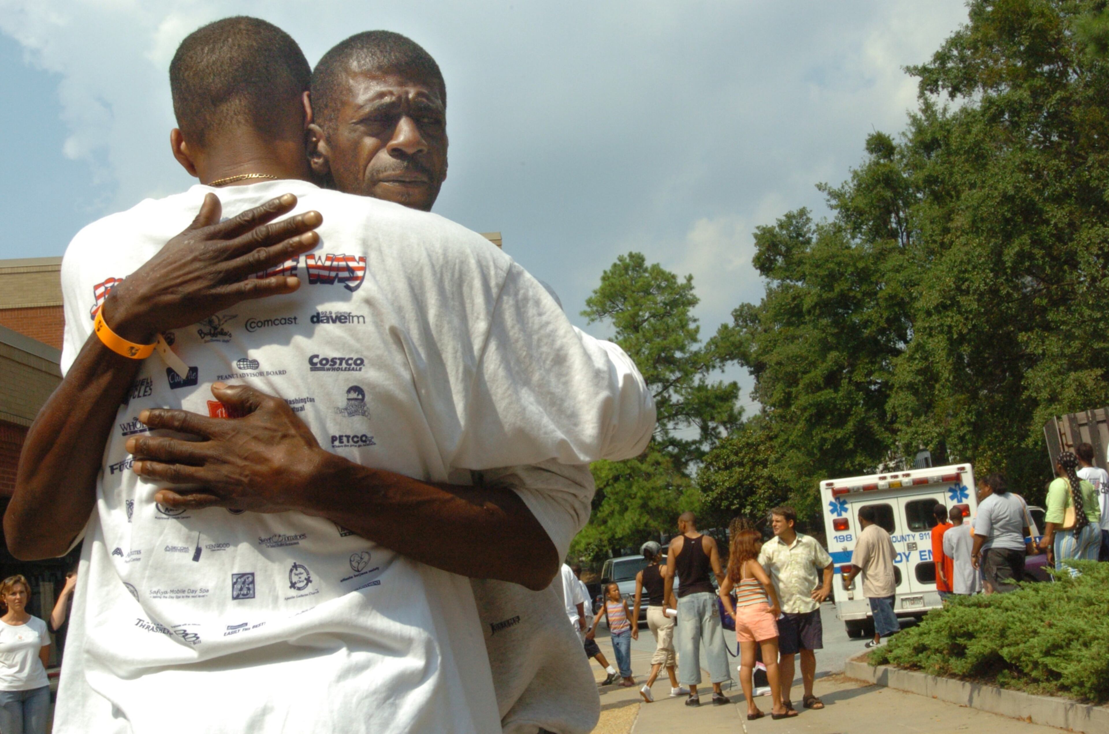 050903 Atlanta Ga: Georgia Tech has opened it's coliseum to house storm victims from New Orleans. Ray Willis (cq) (RT) from New Orleans who lost everything gets a hug of encouragement from Anthony Woodard (cq) (LFT/BACK TO CAMERA) of Elizabeth Baptist Church in Atlanta Georgia. Sept 3, 2005 (Renee' Hannans Henry/Staff).