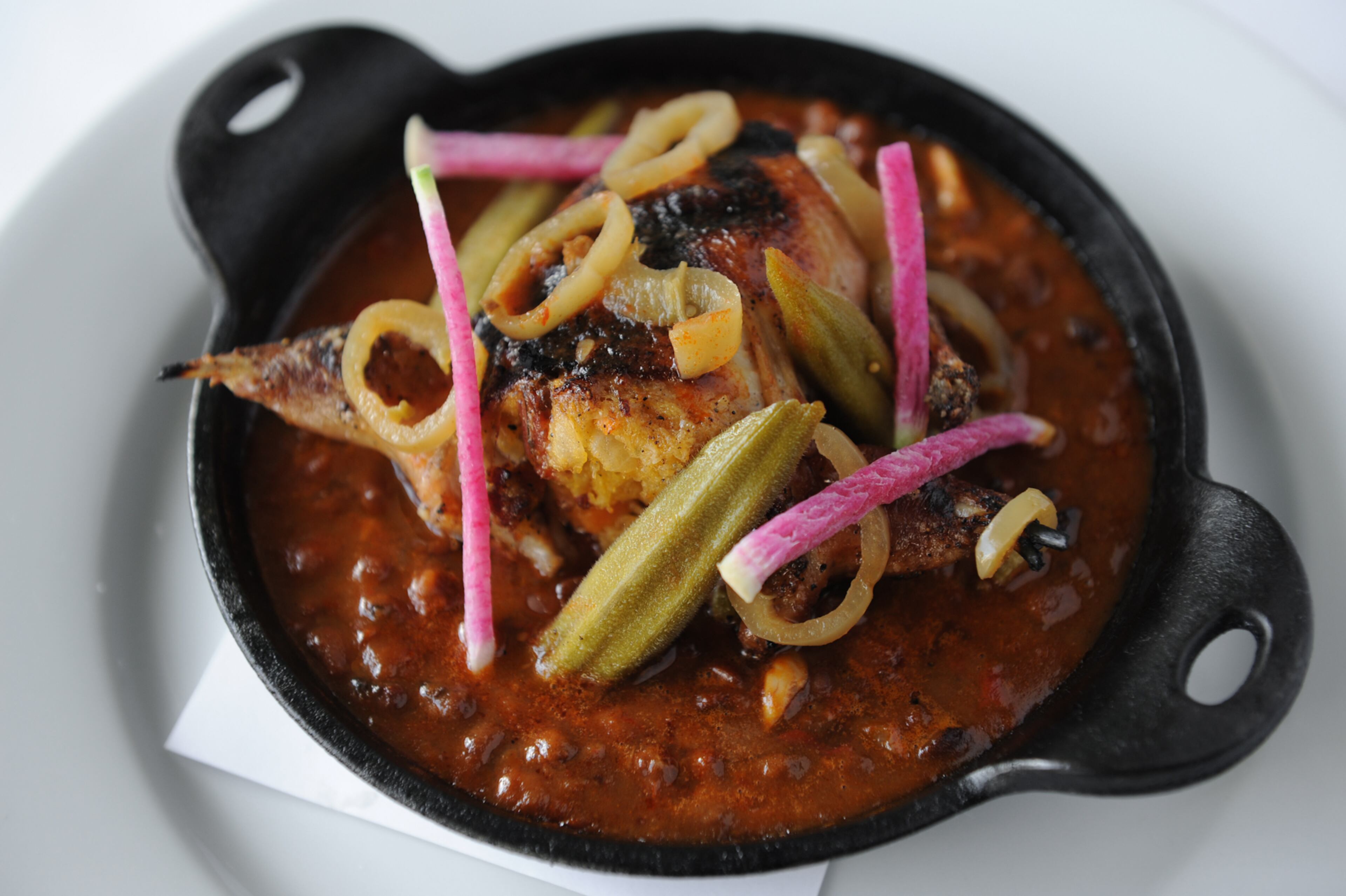 Andouille-stuffed quail with baked field peas and hot pepper vinegar at haven. (BECKY STEIN)