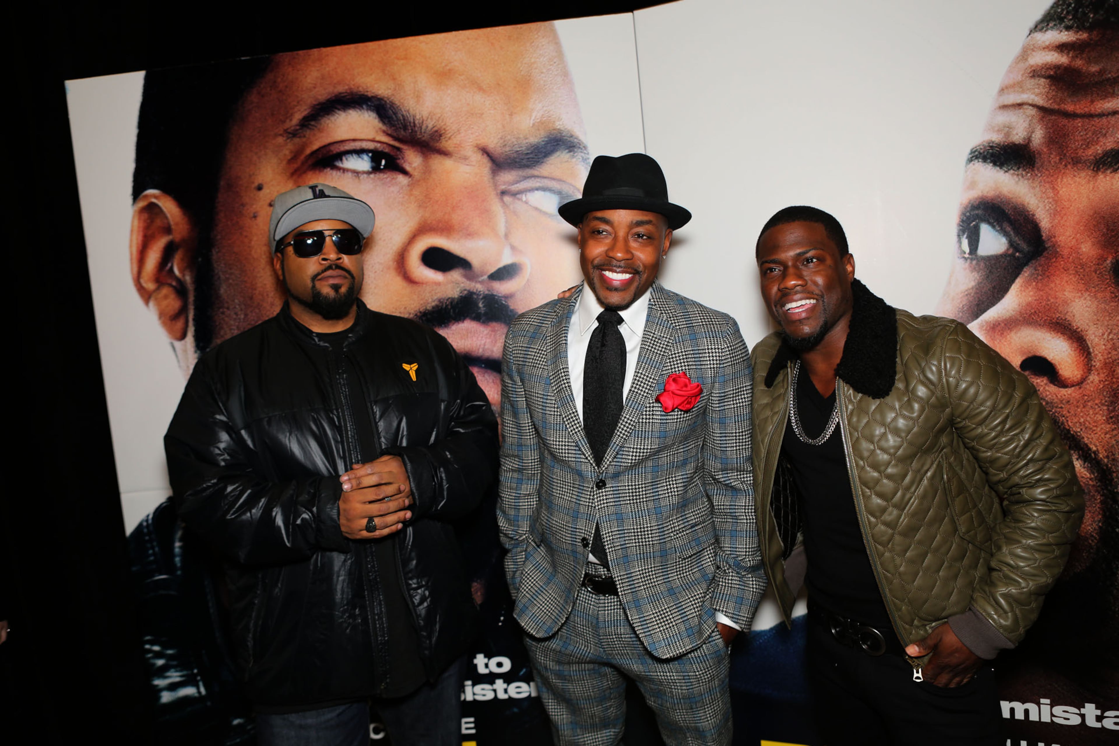 Ice Cube, left, and Kevin Hart, right, stars of the comedy action film "Ride Along," pose with producer Will Packer, at the film's red carpet premier at the Atlantic Station Regal Movie Theater in Atlanta Monday, Jan. 6, 2014.