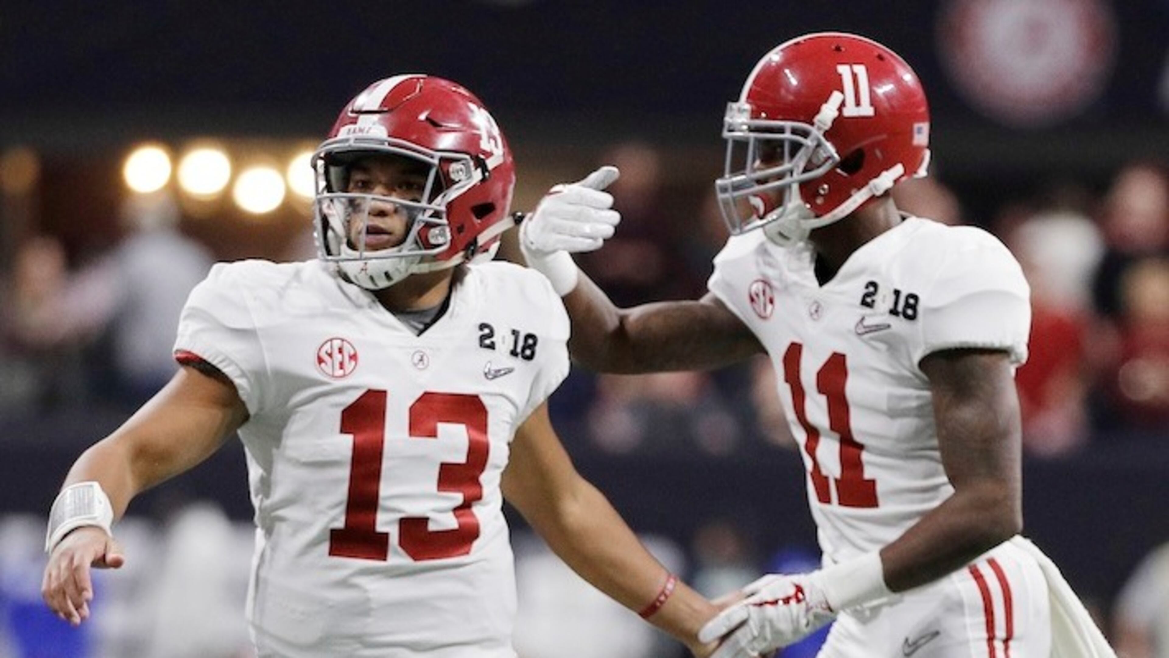 Alabama quarterback Tua Tagovailoa congratulates Henry Ruggs III (11) after his touchdown catch during the second half of the NCAA college football playoff championship game against Georgia, Monday, Jan. 8, 2018, in Atlanta. (AP Photo/David J. Phillip)