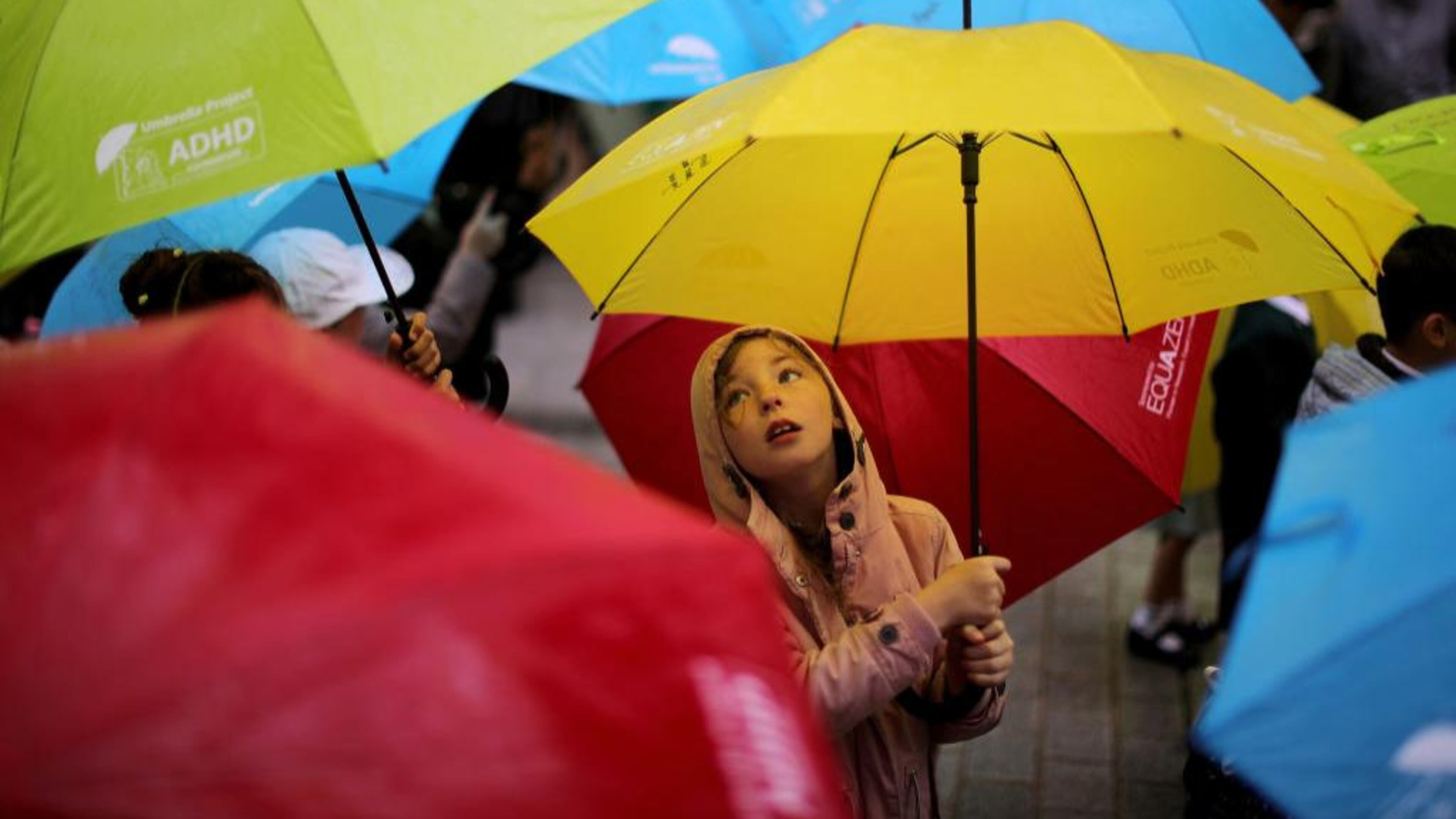 Children dance with their umbrellas at the launch of an art installation called the Umbrella Project on June 22, 2017 in Liverpool, England. The project was aimed at raising awareness of ADHD and autism in children.
