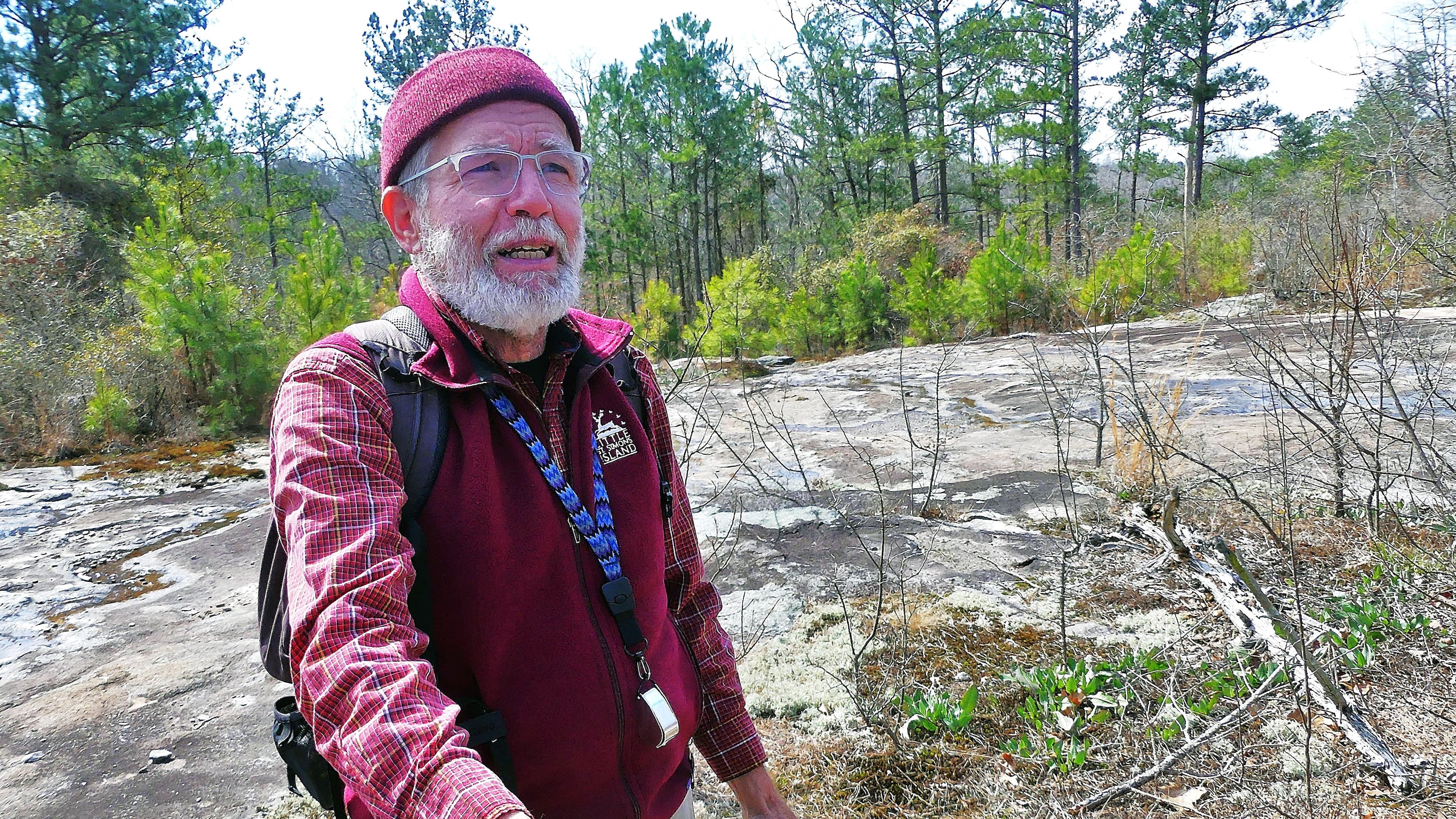 Malcolm Hodges, one of Georgia's leading experts on lichens, holds a species of lichens growing on a granite outcrop at Chattahoochee Bend State Park in Coweta County. (Photo: Charles Seabrook)