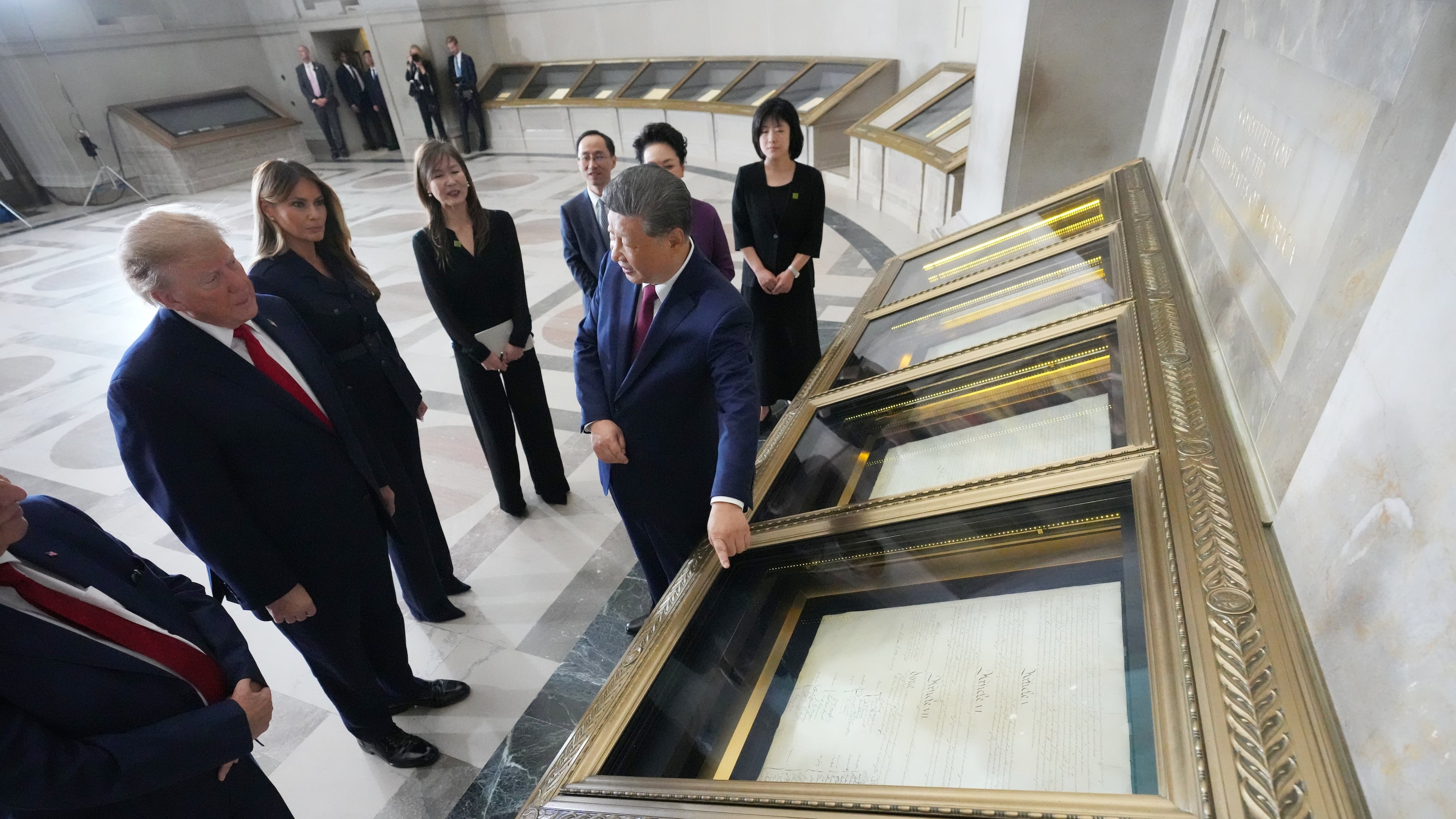 President Donald Trump, first lady Melania Trump, China's President Xi Jinping and his wife Peng Liyuan, with Bradford Wilson, Archivist of the United States, view the Constitution, Bill of Rights and other documents at the National Archives, Friday, Sept. 25, 2026, in Washington. (AP Photo/Alex Brandon)