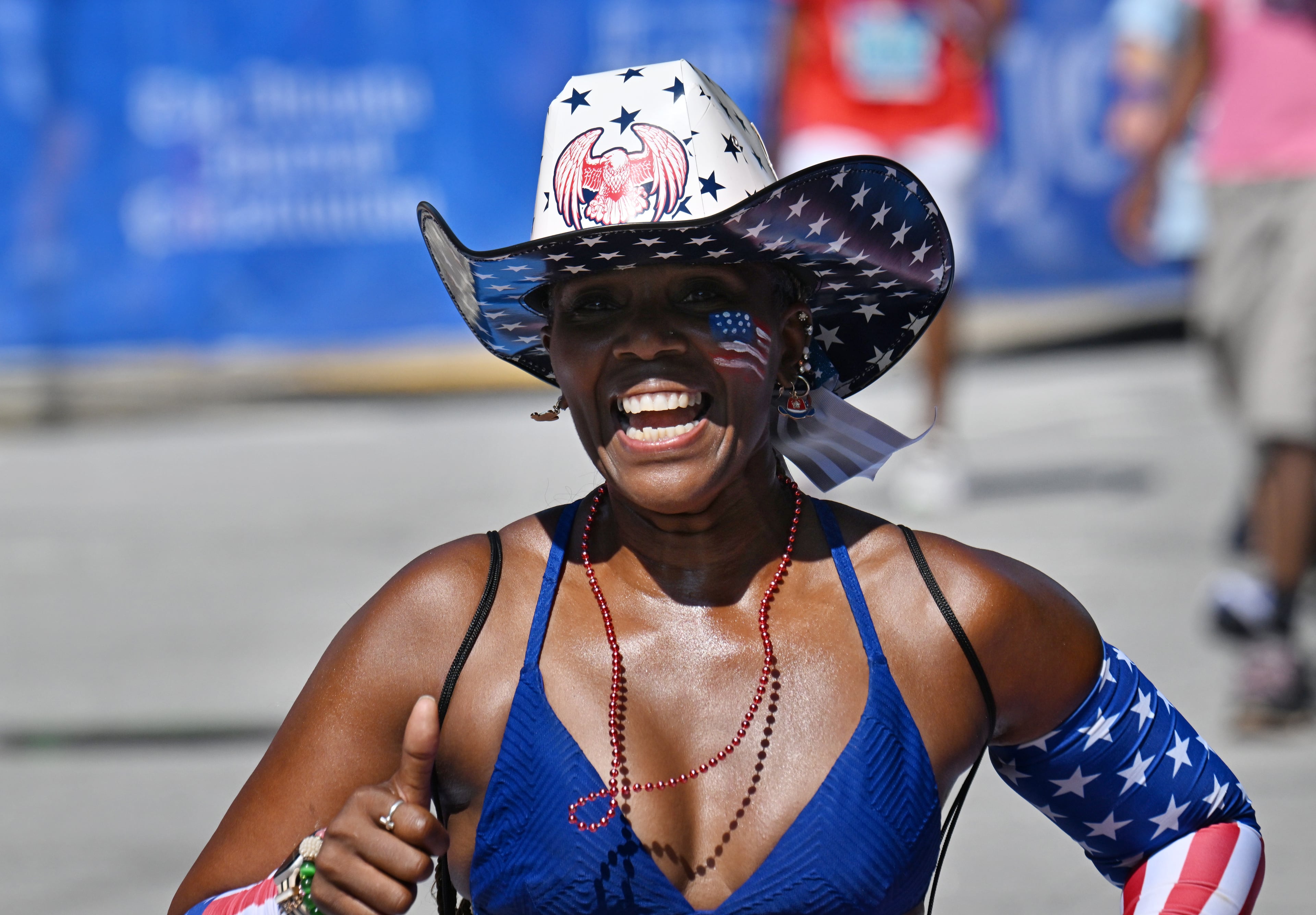 Runners celebrate as they cross the finish line of the 56th running of the Atlanta Journal-Constitution Peachtree Road Race in Atlanta on Friday, July 4, 2025. (Hyosub Shin / AJC)