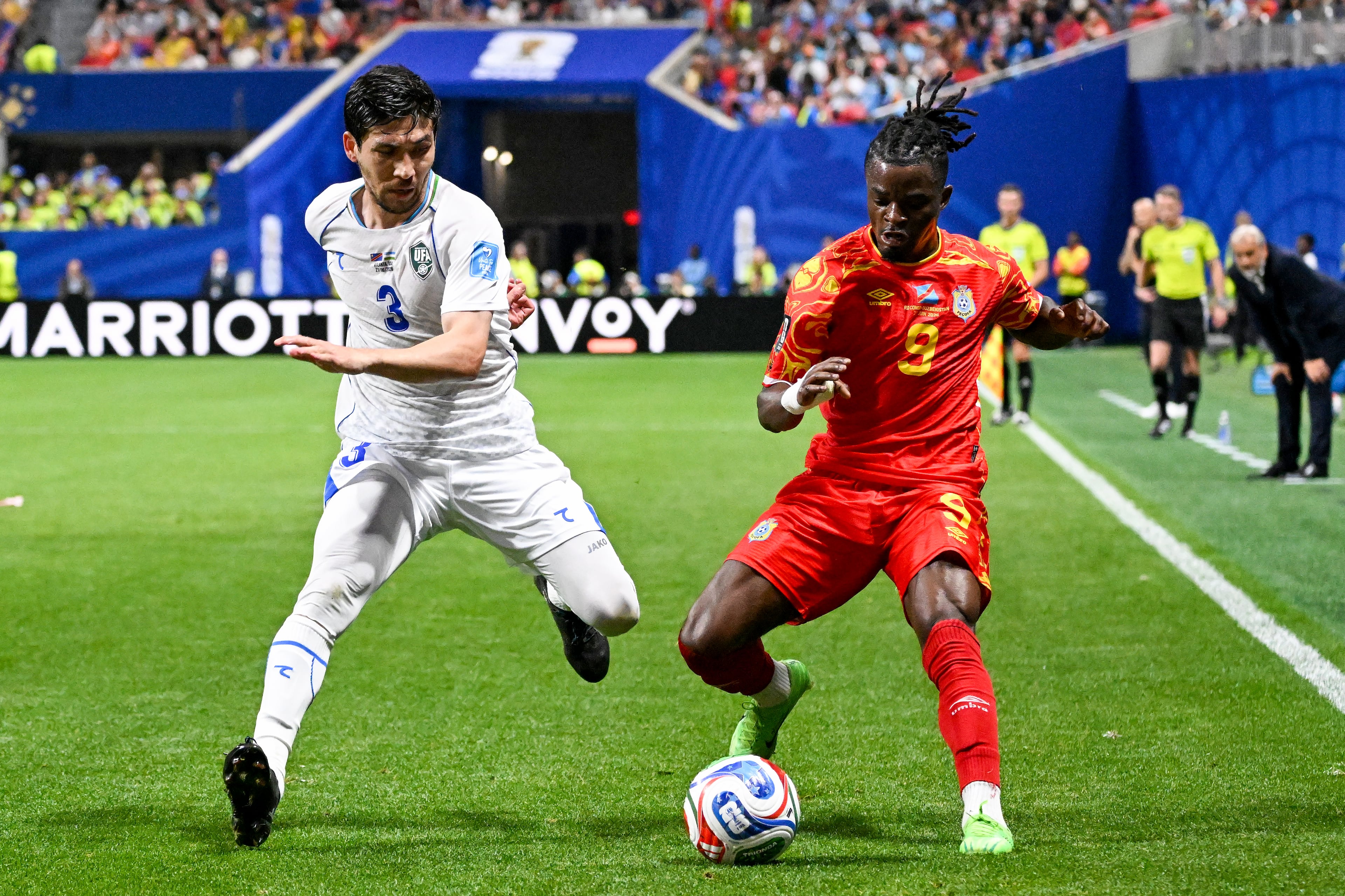 Uzbekistan defender Khojiakbar Alijonov (left) and Congo forward Brian Cipenga (right) battle for control during the first half of a FIFA World Cup match at Atlanta Stadium (Mercedes-Benz Stadium) on Saturday, June 27, 2026, in Atlanta. (Hyosub Shin/AJC)
