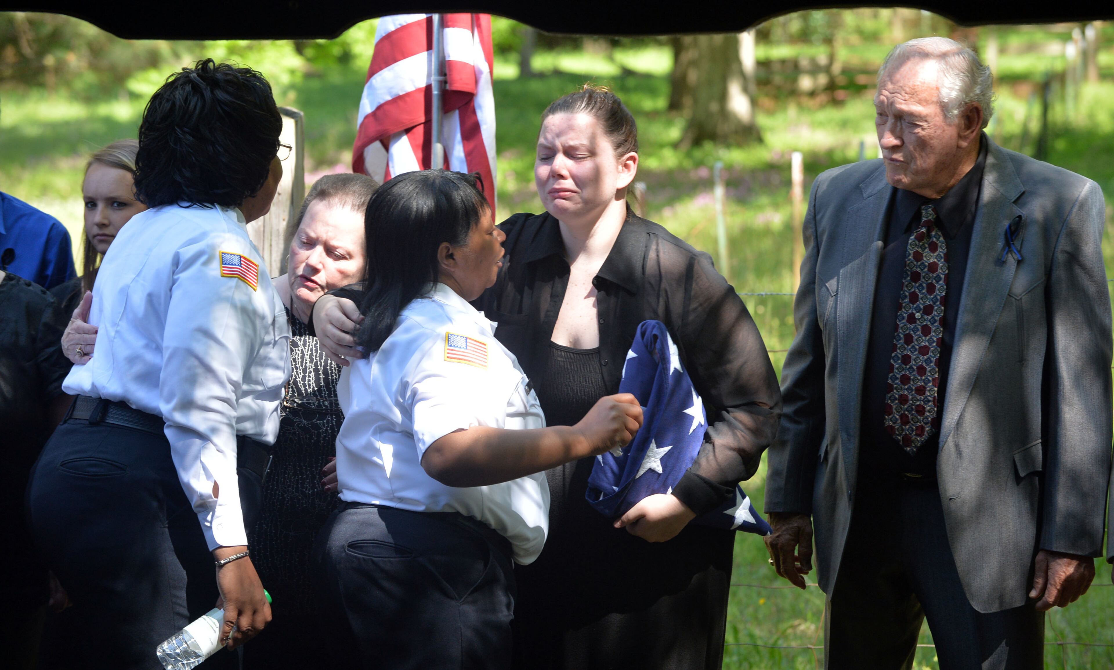Officer Hawk's mother, Martha (left), daughter Victoria, and father, Bobby Hawk, greet well-wishers following the ceremony at A.E. Carter Funeral Home in Madison, Ga. Officer Noel Hawk suffered a fatal heart attack shortly after breaking up at a fight at a fast food restaurant in Eatonton May 4. He was 52 and had served with the Eatonton Police Department for 12 years. He is survived by his parents, brother Neal and five children.