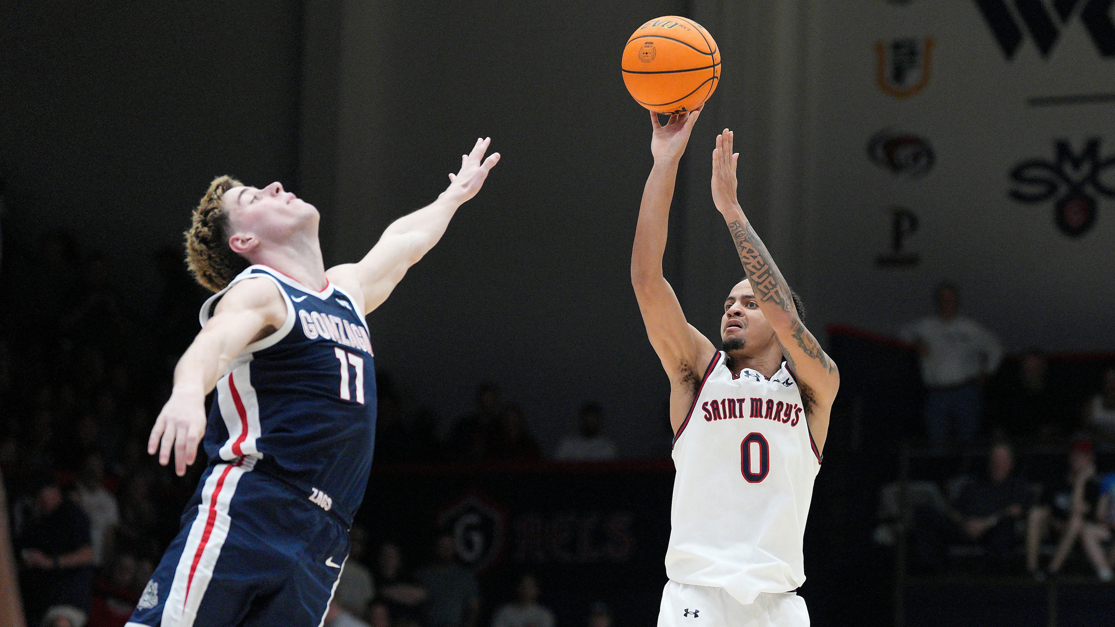 Saint Mary's guard Mikey Lewis (0) shoots over Gonzaga guard Mario Saint-Supery (17) during the second half of an NCAA college basketball game in Moraga, Calif., Saturday, Feb. 28, 2026. (AP Photo/Tony Avelar)
