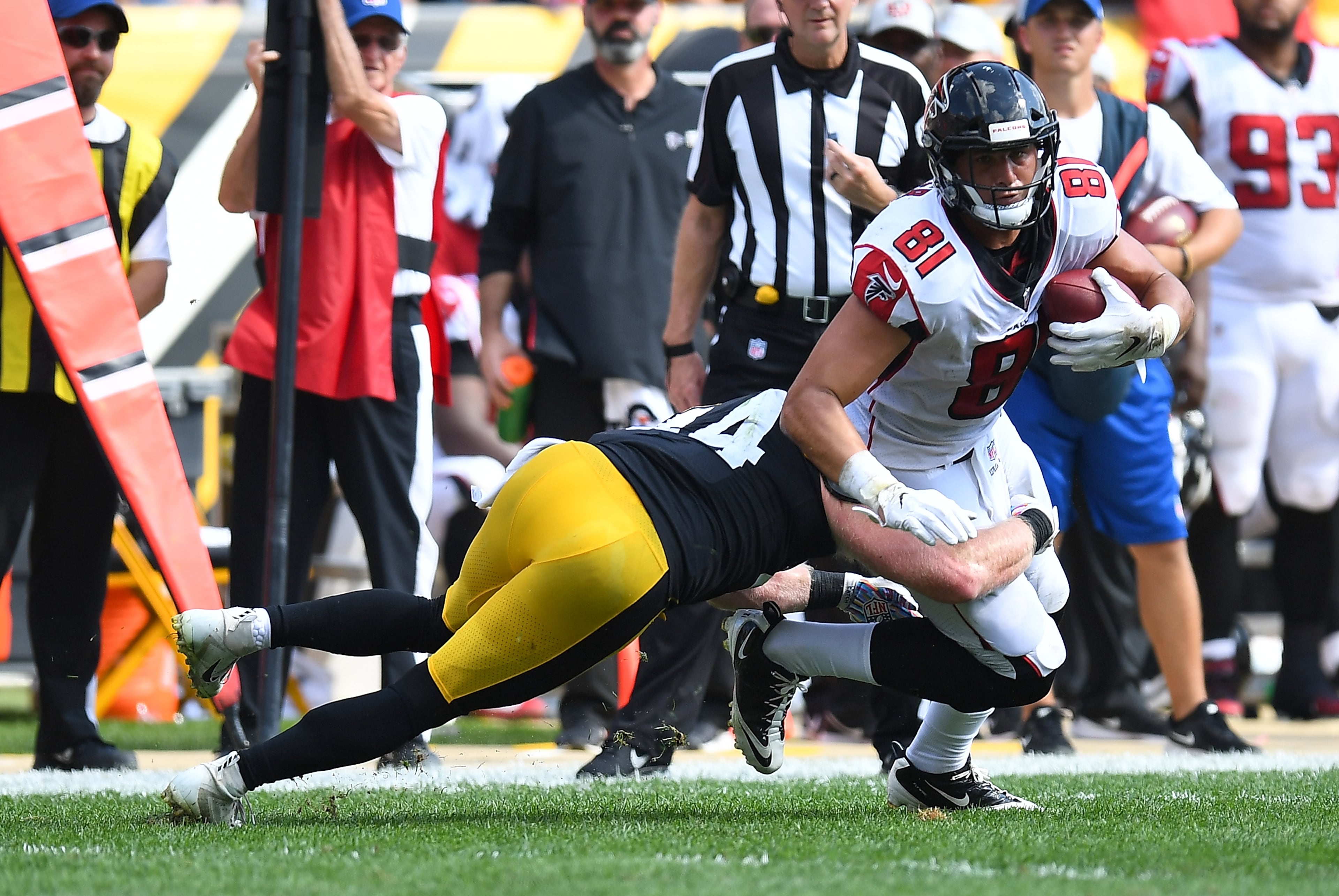 Austin Hooper is wrapped up for a tackle by Tyler Matakevich. (Photo by Joe Sargent/Getty Images)