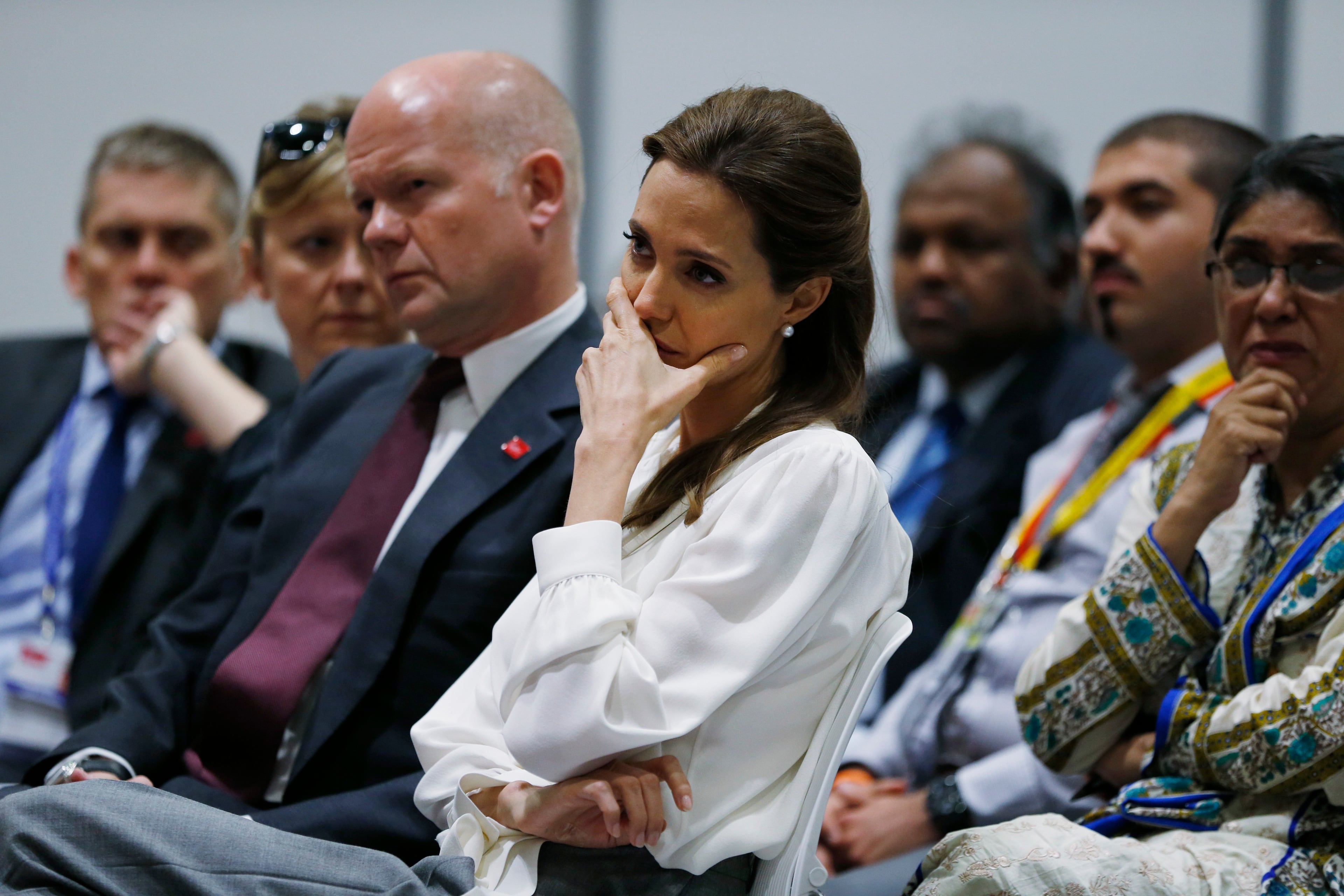 US actress Angelina Jolie, centre, Special Envoy of the United Nations High Commissioner for Refugees, listens to a speech of a delegate at the 'End Sexual Violence in Conflict' summit in London, Wednesday, June 11, 2014. The Summit welcomes governments from over 100 countries, over 900 experts, NGOs, Faith leaders, and representatives from international organizations across the world. (AP Photo/Lefteris Pitarakis, pool)