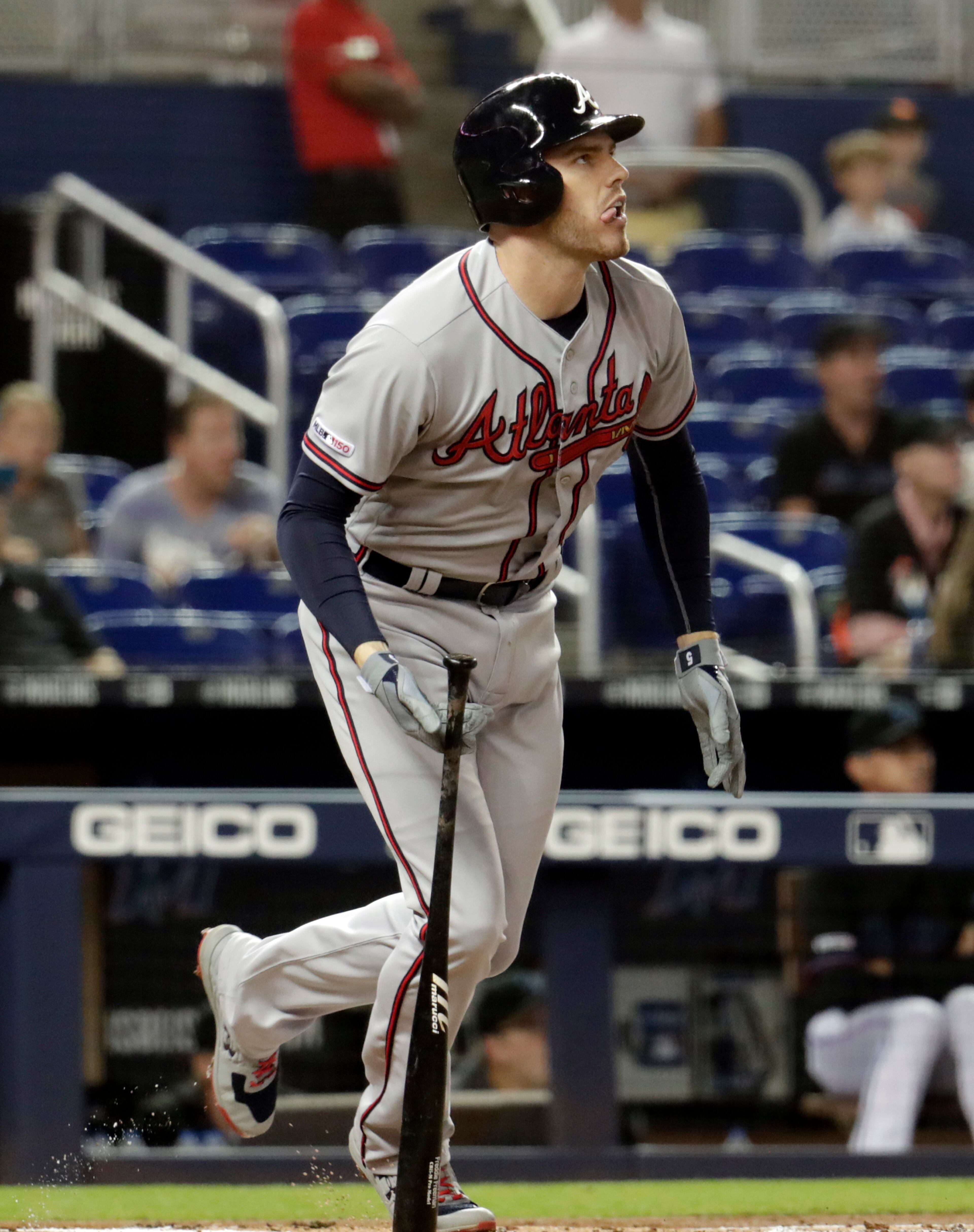 Atlanta Braves' Freddie Freeman watches his solo home run during the first inning of the team's baseball game against the Miami Marlins on Friday, May 3, 2019, in Miami. (AP Photo/Lynne Sladky)