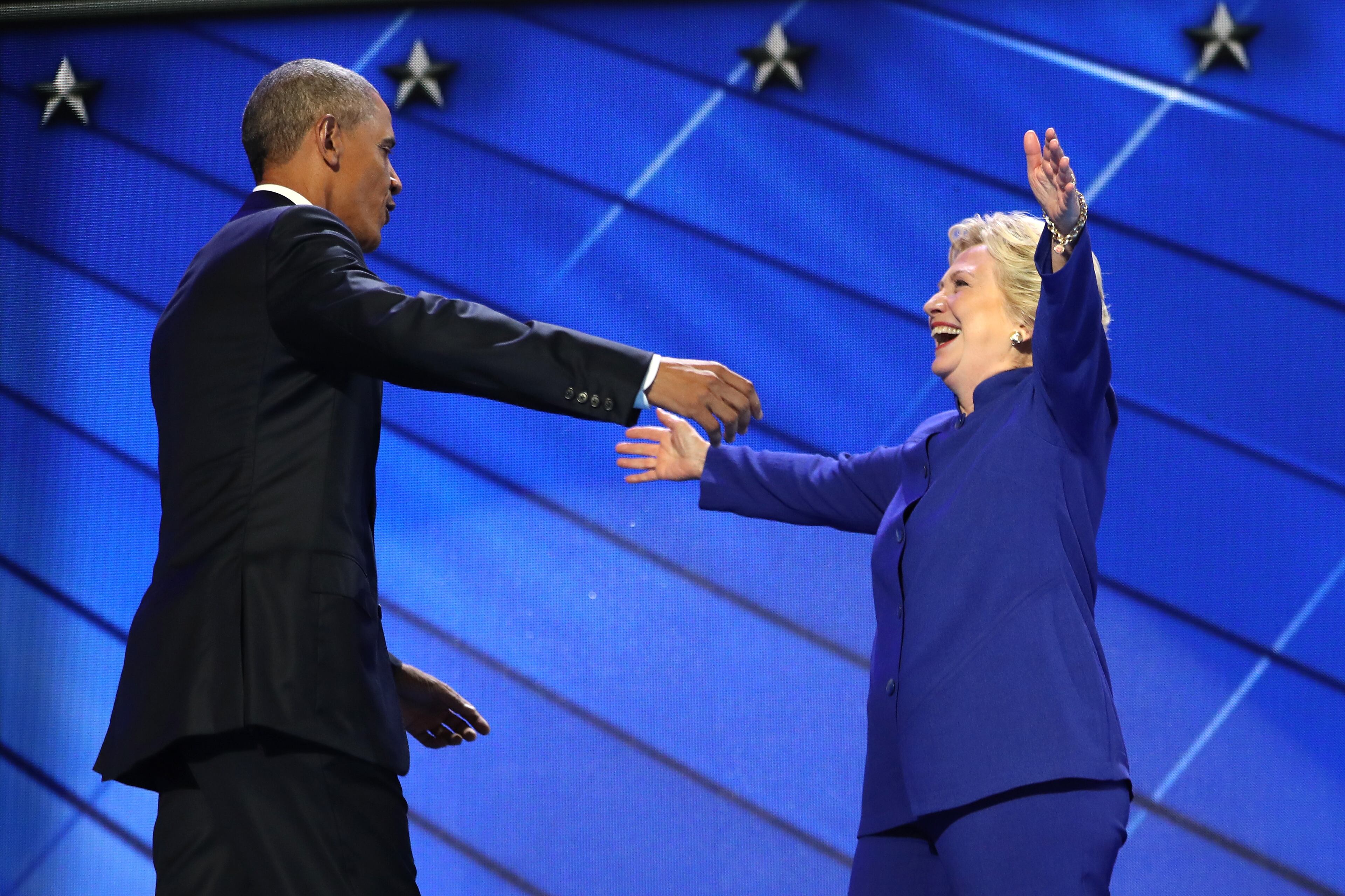 President Barack Obama and Democratic presidential candidate Hillary Clinton embrace on the third day of the Democratic National Convention at the Wells Fargo Center, July 27, 2016 in Philadelphia (Photo by Joe Raedle/Getty Images)