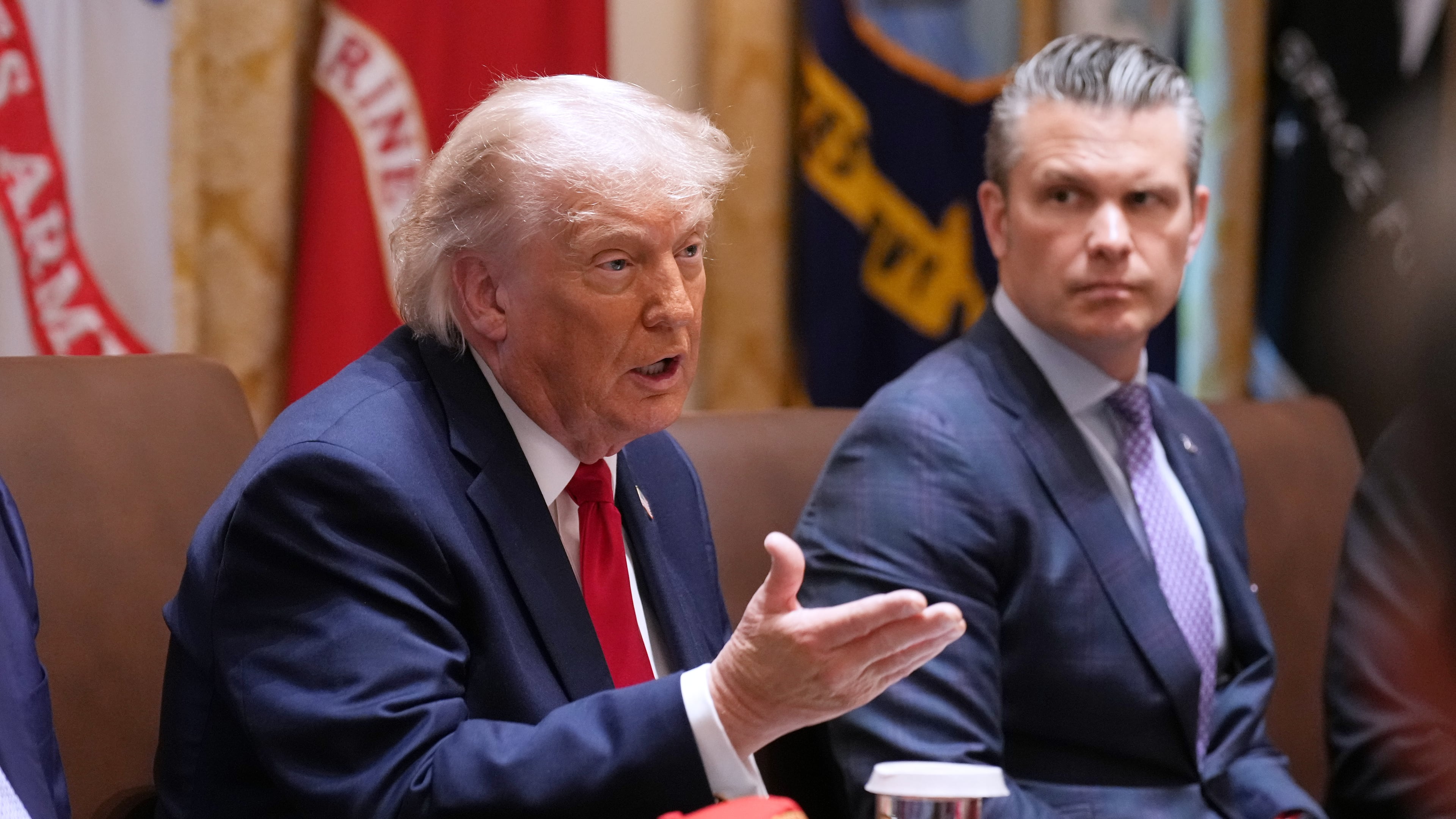 President Donald Trump speaks during a Cabinet meeting at the White House, Wednesday, May 27, 2026, in Washington, as Secretary of Defense Pete Hegseth, looks on. (AP Photo/Jacquelyn Martin)