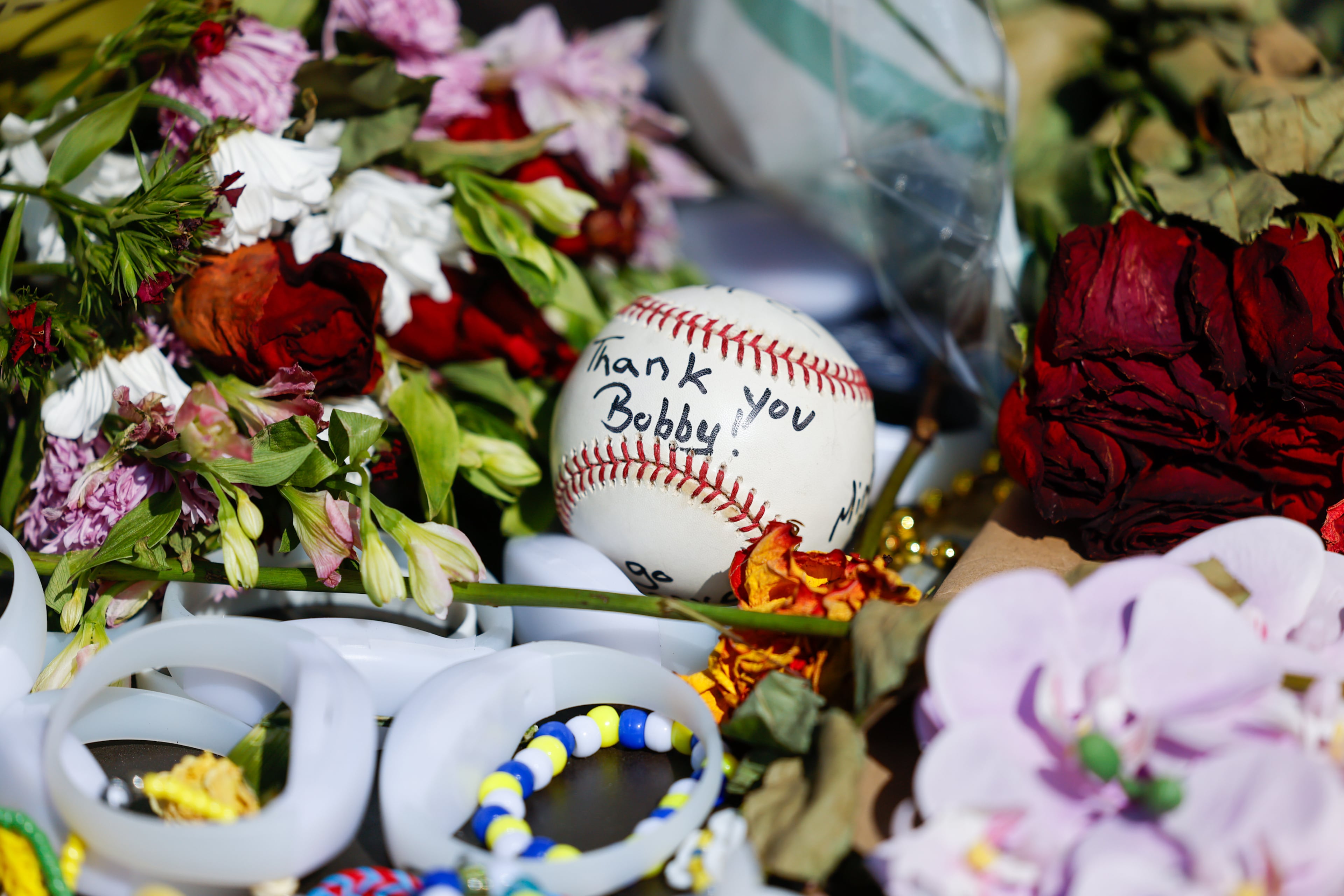 Fans left flowers and other items for the late legendary Braves manager Bobby Cox by his statue at Truist Park in Atlanta on May 12, 2026. Cox died at age 84 on Saturday May, 9. (Arvin Temkar/AJC)