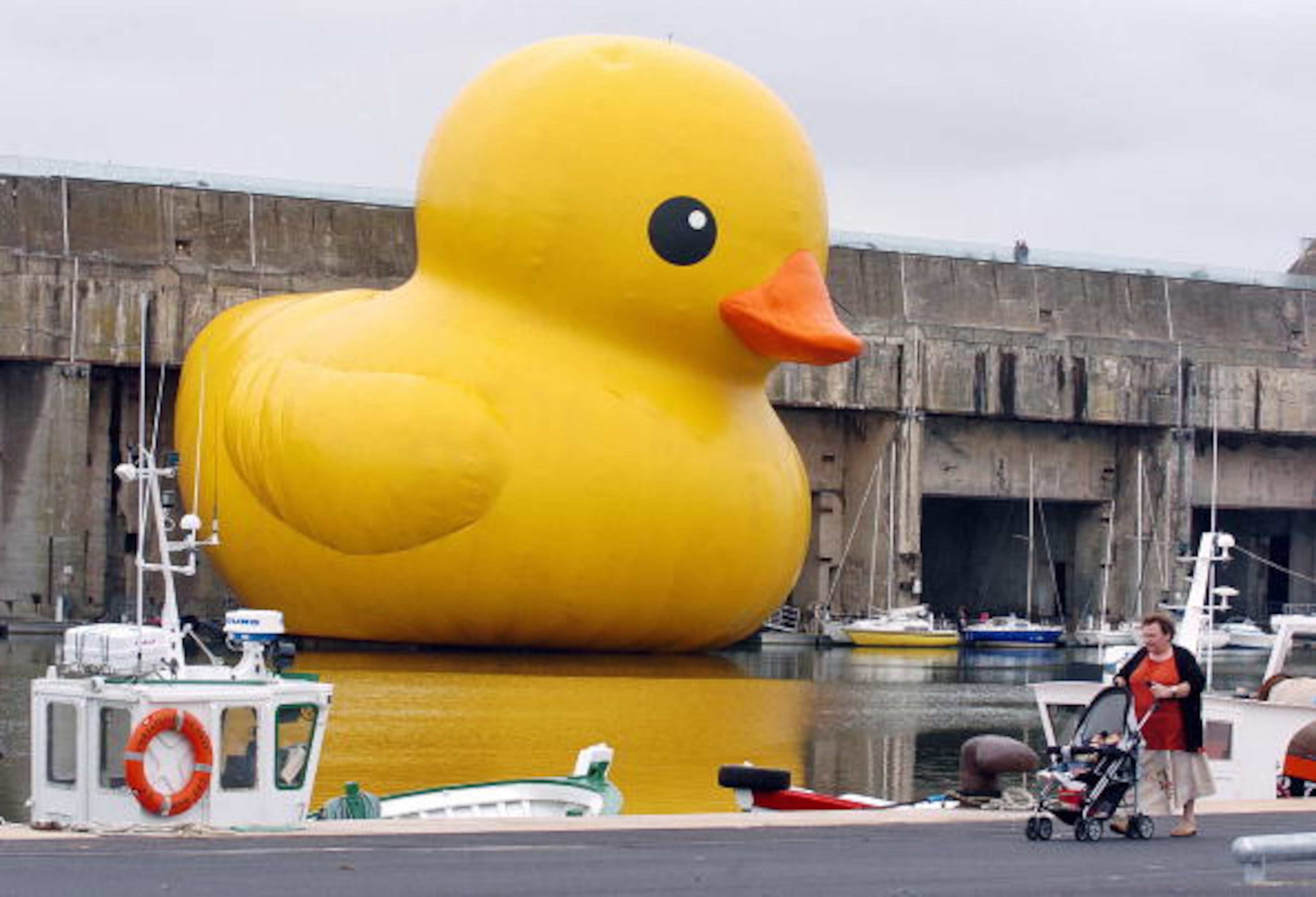 Saint-Nazaire, FRANCE: "Bathduck", an inflatable giant duck made by Dutch artist Florentijn Hofman, with giant dimension as 25 metre-high and 32 metre-large, is pictured 07 July 2007 in Saint-Nazaire harbour during a cultural event named "Estuary 2007" taking place all along the Loire river, from Nantes to Saint-Nazaire, until 01 Spetember 2007. AFP PHOTO FRANK PERRY (Photo credit should read FRANK PERRY/AFP/Getty Images)