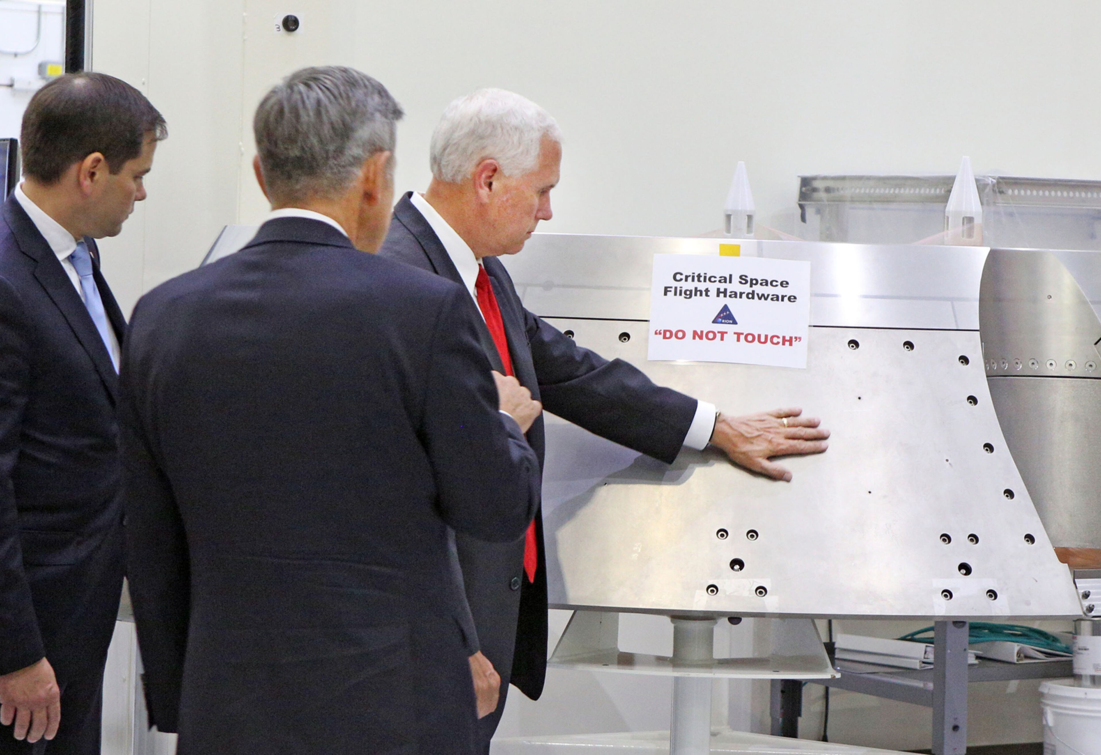 Vice President Mike Pence, right, gets a tour of the Orion clean room with Sen. Marco Rubio, left, by Bob Cabana, Director Kennedy Space Center, center, Thursday, July 6, 2017. (Red Huber/Orlando Sentinel/TNS)