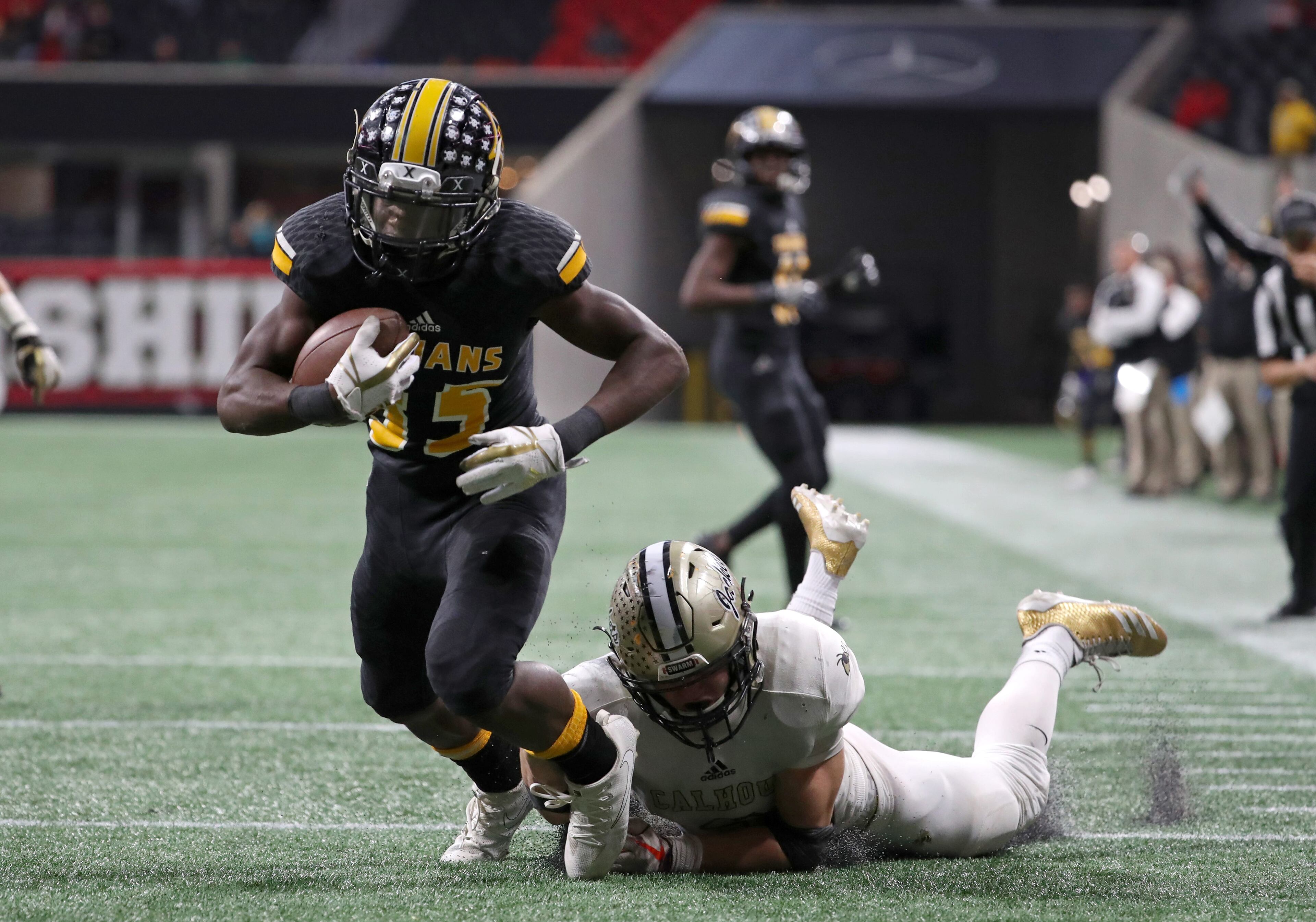 On 4th down, Peach County wide receiver Noah Whittington (35) is tackled by Calhoun defensive back Brannon Spector (3) after apparently catching a pass deep in Calhoun territory in the fourth quarter of the Class AAA Championship at Mercedes-Benz Stadium Friday, December 8, 2017, in Atlanta. The play was ruled an incomplete pass turning the ball over on downs. Calhoun won 10-6. PHOTO / JASON GETZ