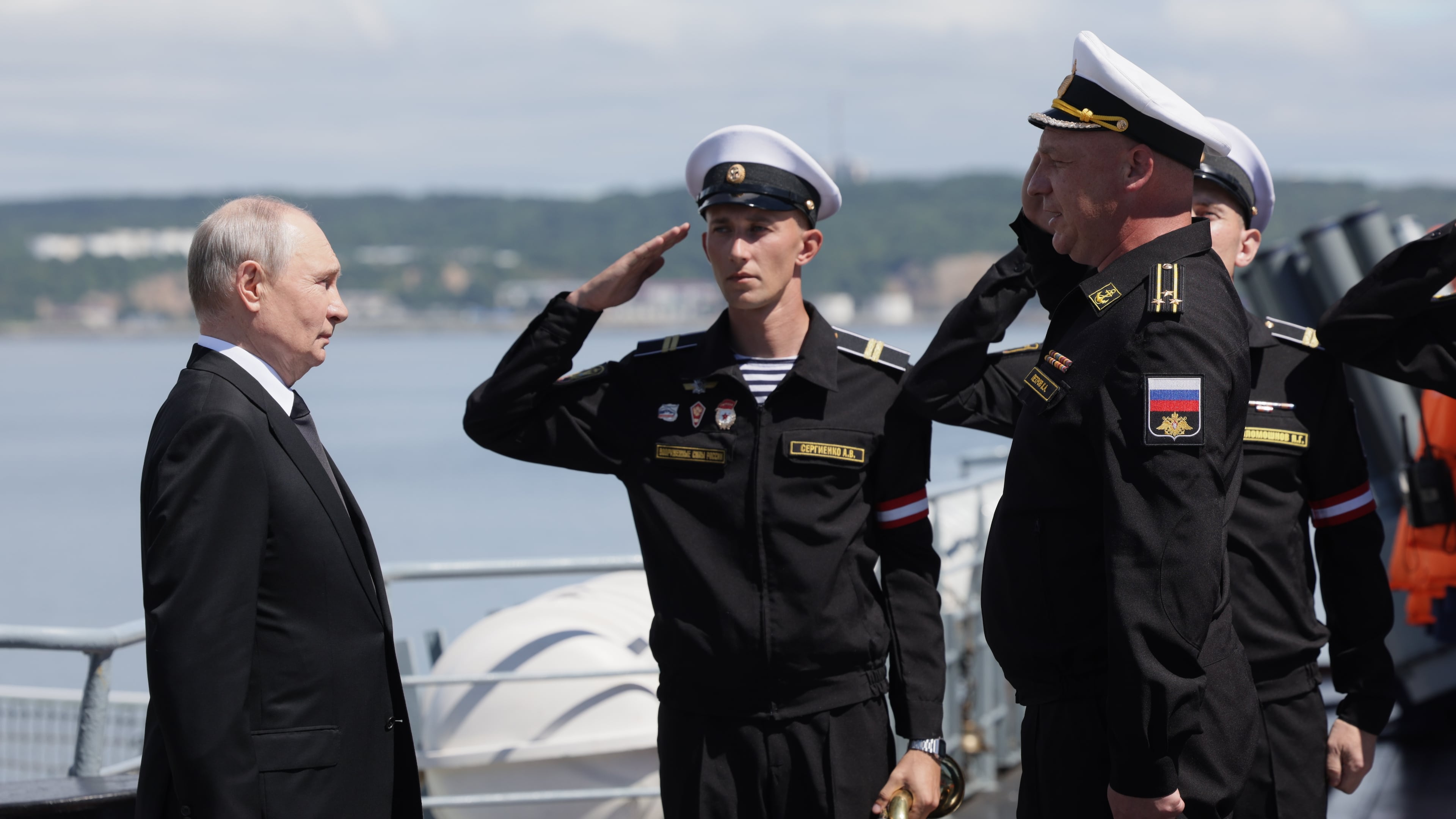 Russian President Vladimir Putin, left, visits the Varyag missile cruiser of the Pacific Fleet to watch a military exercise near Yuzhno-Sakhalinsk, on Sakhalin Island, Russia, Wednesday, Aug. 12, 2026. (Gavriil Grigorov, Sputnik, Kremlin Pool Photo via AP)