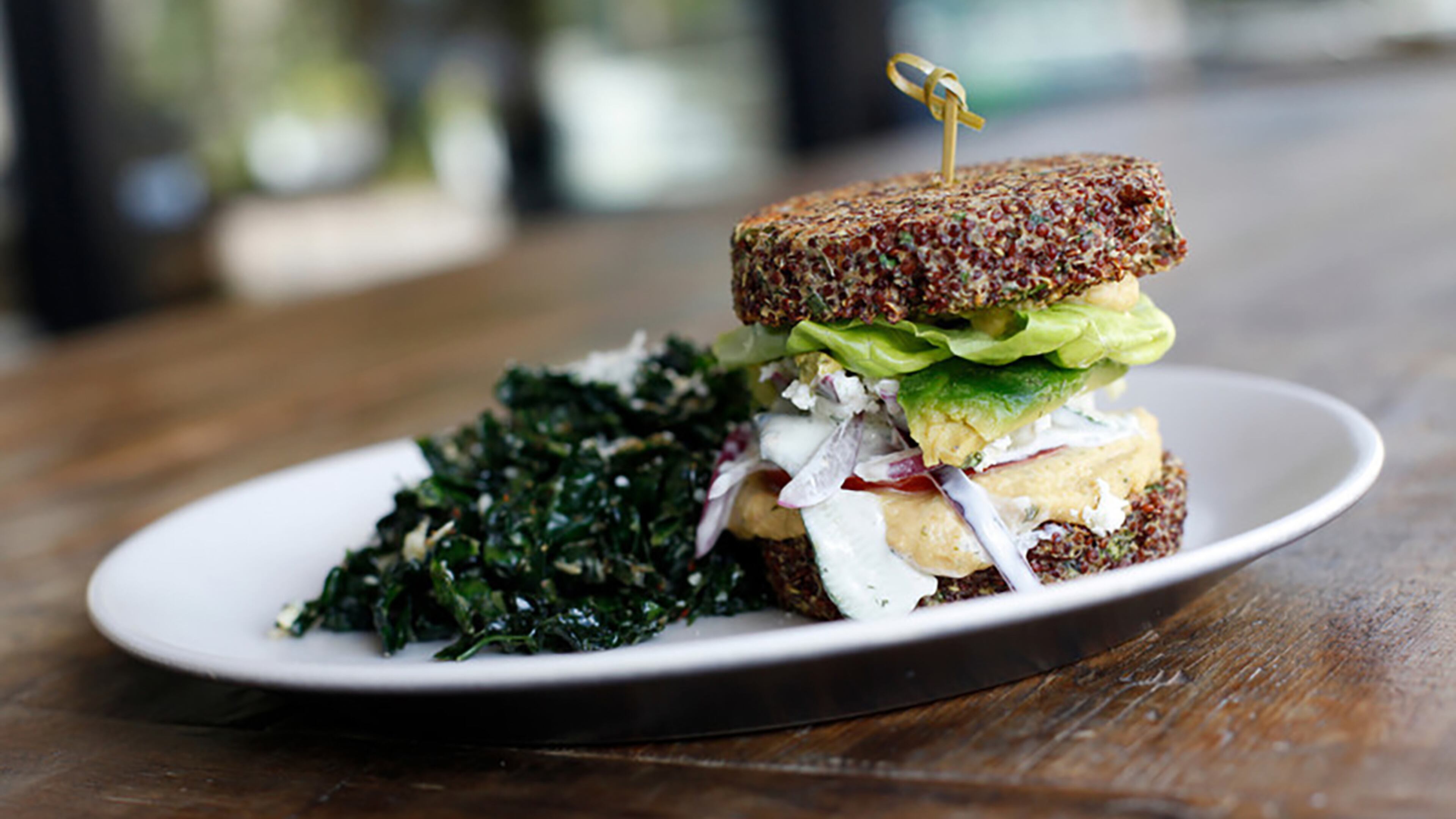 True Food Kitchen's 'Inside Out' Quinoa Burger, which is gluten-free, is made with hummus, tzatziki, tomato, cucumber, red onion, avocado and feta, and sandwiched between two quinoa patties. Photo courtesy of True Food Kitchen