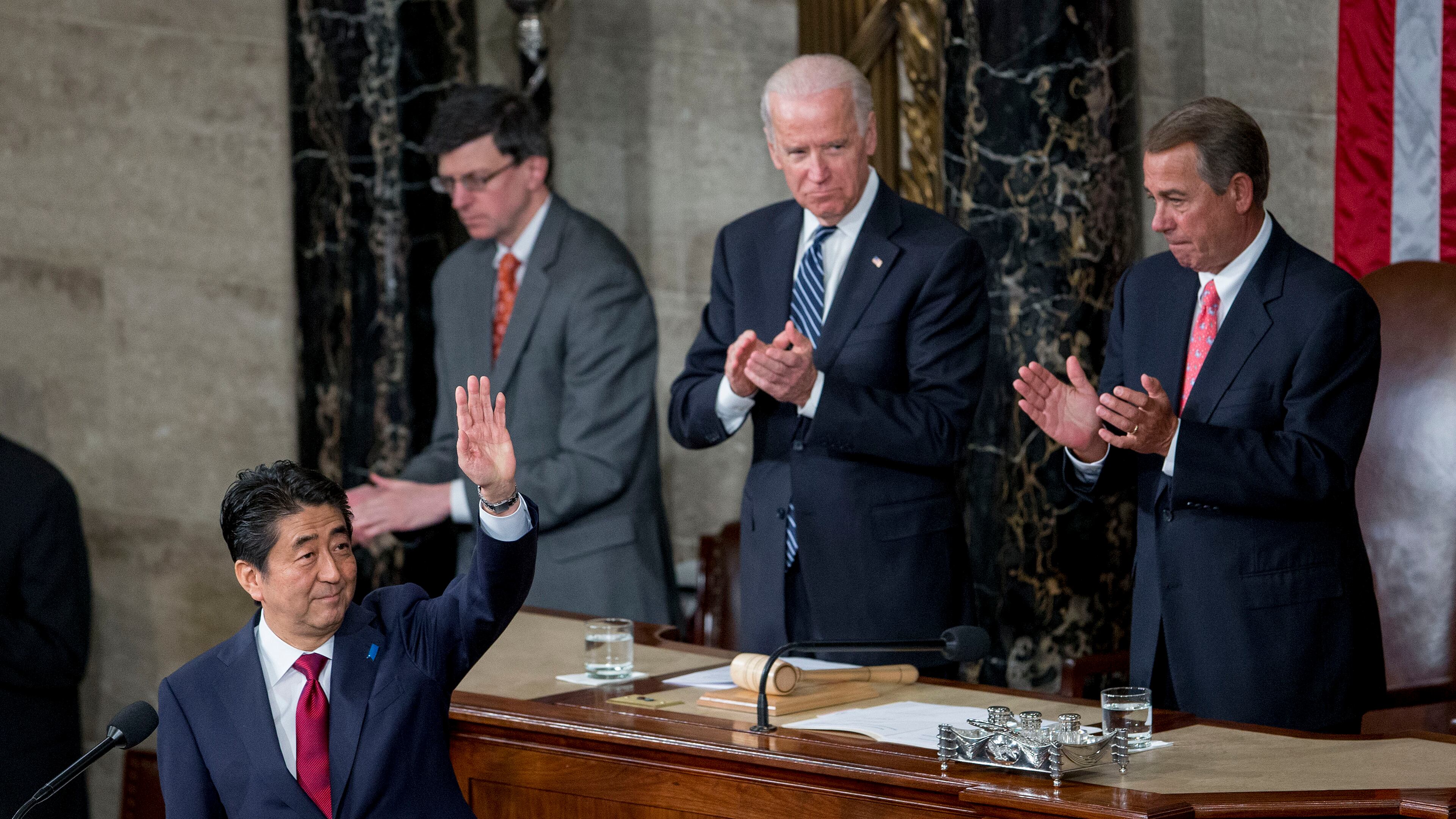 Shinzo Abe, Japan's prime minister, left, waves after speaking during a joint meeting of Congress with U.S. House Speaker John Boehner, a Republican from Ohio, right, and, U.S. Vice President Joseph "Joe" Biden, top left, in the House Chamber at the U.S. Capitol in Washington, D.C., U.S., on Wednesday, April 29, 2015. Abe urged the U.S. to work closely with his country in pushing through an ambitious Asia-Pacific trade deal that he says also will promote both democracy and freedom in that region. Photographer: Andrew Harrer/Bloomberg *** Local Caption *** Shinzo Abe; John Boehner; Joe Biden Shinzo Abe, Japan's prime minister, left, waves after speaking last week during a joint meeting of Congress with U.S. House Speaker John Boehner, a Republican from Ohio, right, and, U.S. Vice President Joe Biden. Abe urged the U.S. to work closely with his country in pushing through an ambitious Asia-Pacific trade deal that he says also will promote both democracy and freedom in that region. Andrew Harrer/Bloomberg