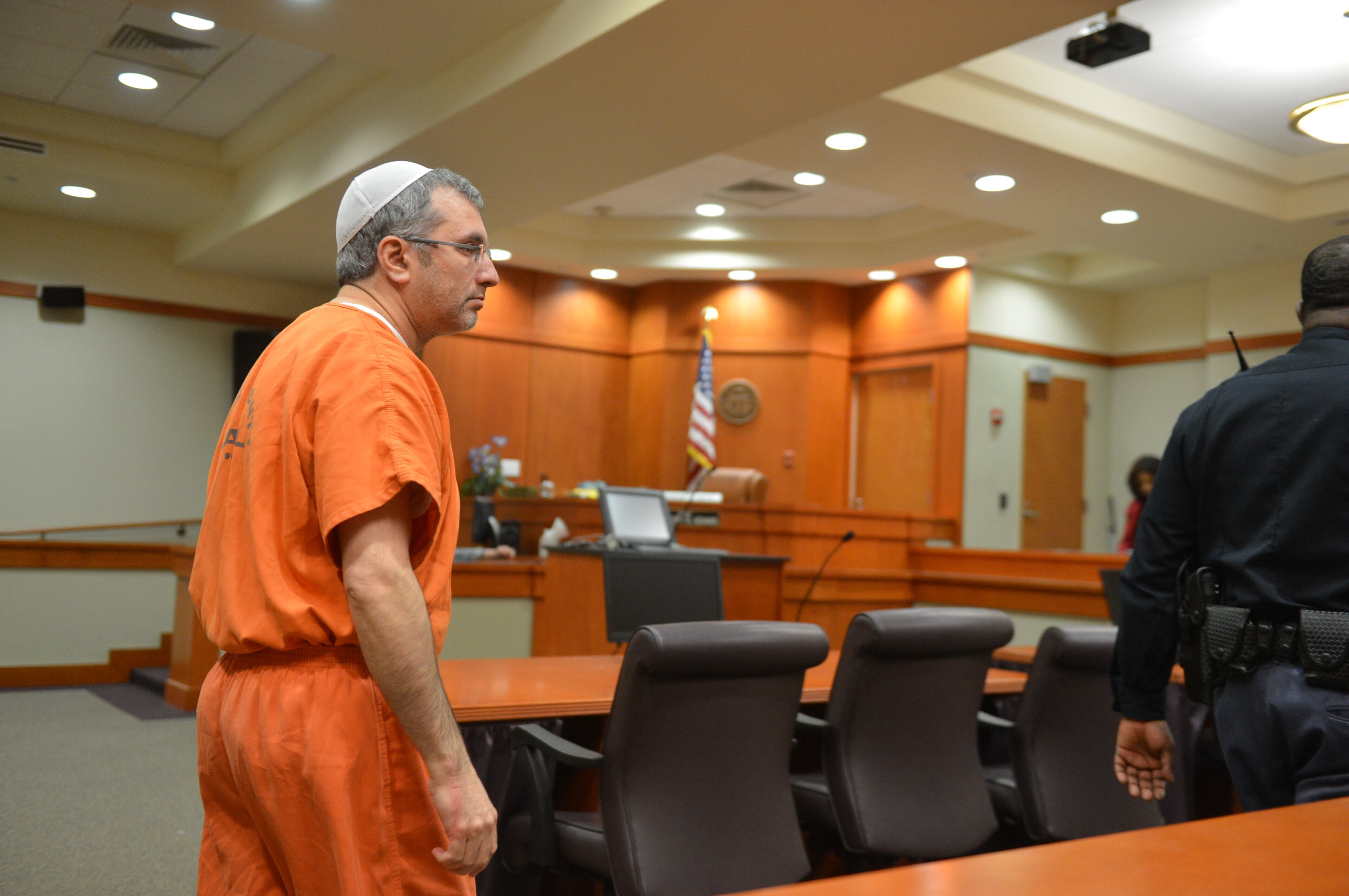Hemy Neuman entered court shortly before 1:30 p.m. Tuesday, wearing an orange DeKalb County jumpsuit. He sat at the defense table with his attorneys, Doug Peters and Bob Rubin. DeKalb Superior Court Judge Gregory A. Adams presided.