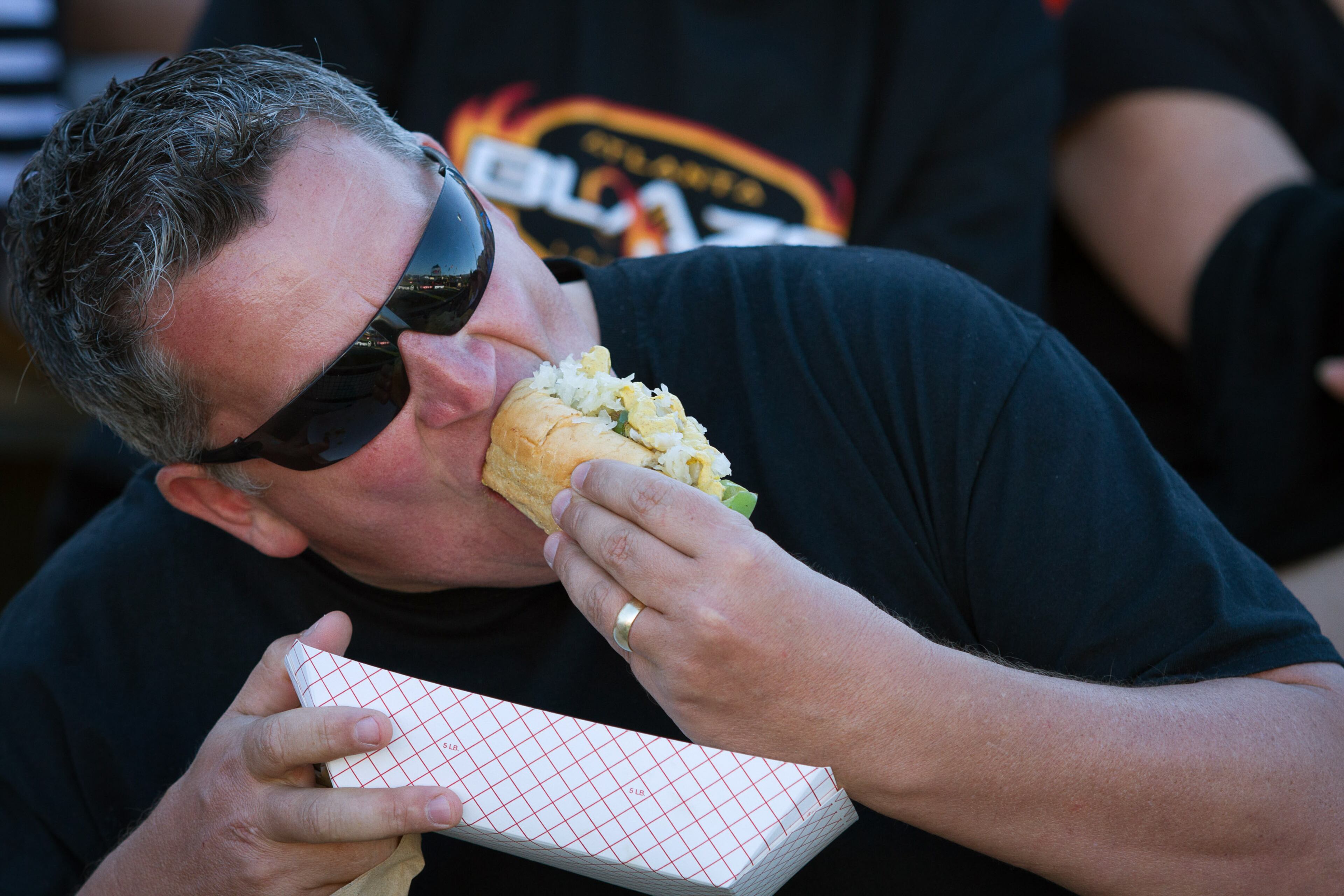 Allen Taylor enjoys a hot dog while watching the Atlanta Blaze play the Chesapeake Bayhawks Saturday night April 23, 2016 in Kennesaw, Ga. Chesapeake Bayhawks beat the Atlanta Blaze in their inaugural game 16-13. STEVE SCHAEFER / SPECIAL TO THE AJC