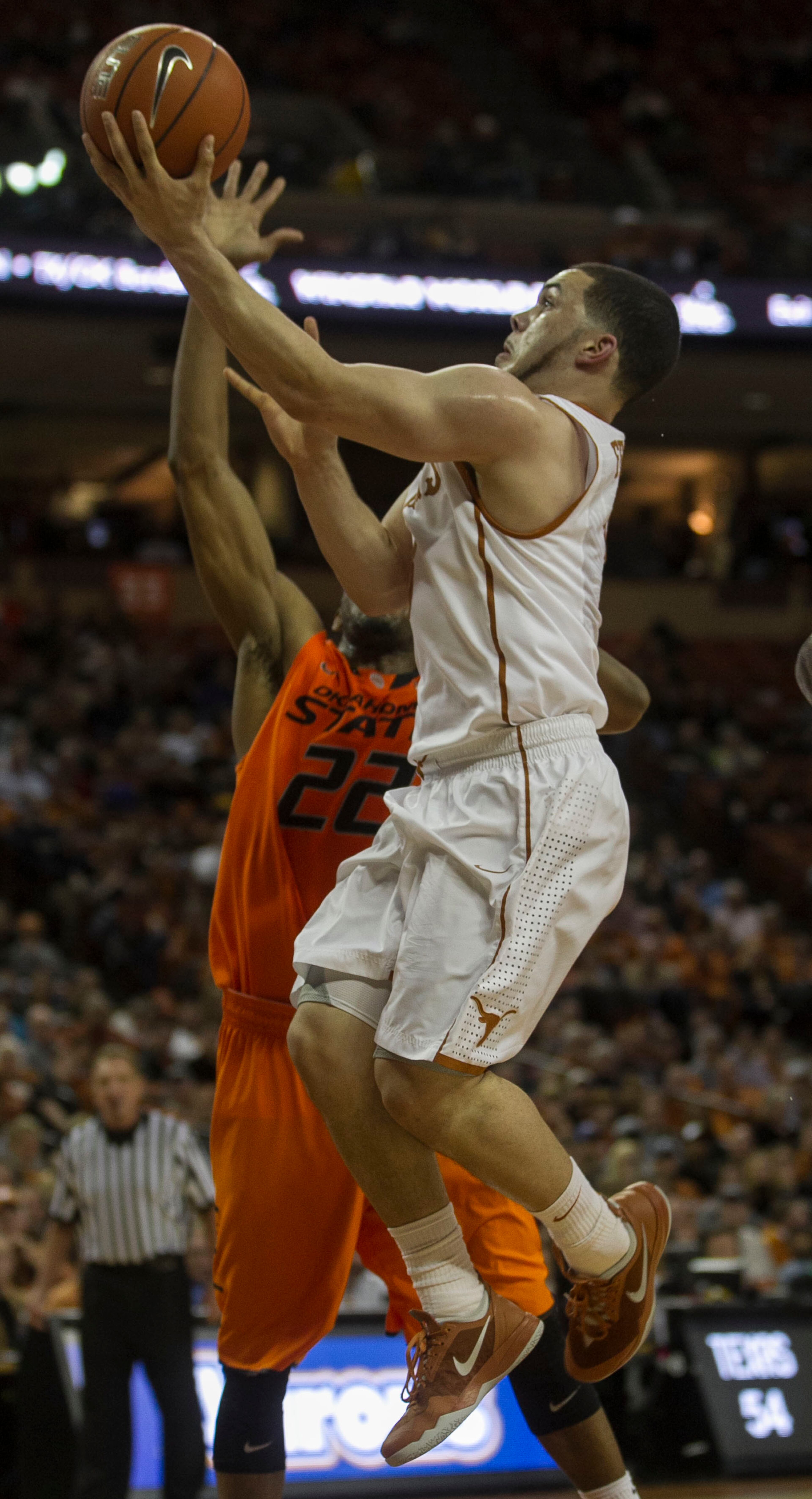 Texas #3, Javan Felix drives to the basket against Oklahoma State #22, Markel Brown during the first half of Big 12 action held at the University of Texas Frank Erwin Center, in Austin, Texas, on Tuesday, February 11, 2014.
