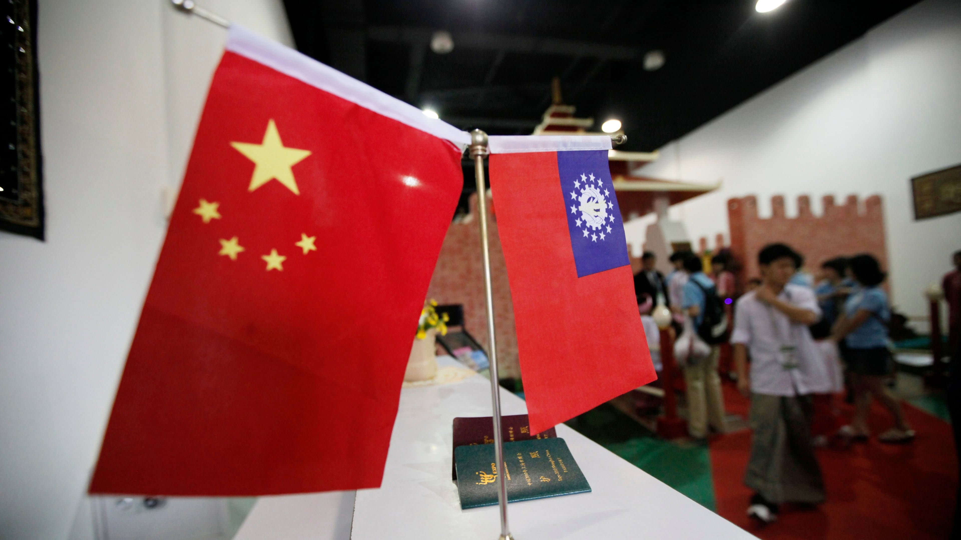 FILE - Flags of China and Myanmar are displayed at the entrance of Myanmar Pavilion prior to Myanmar's top junta leader Gen. Than Shwe to arrive at the Shanghai Expo site in Shanghai Friday, Sept.10, 2010. (AP Photo/Eugene Hoshiko, file)
