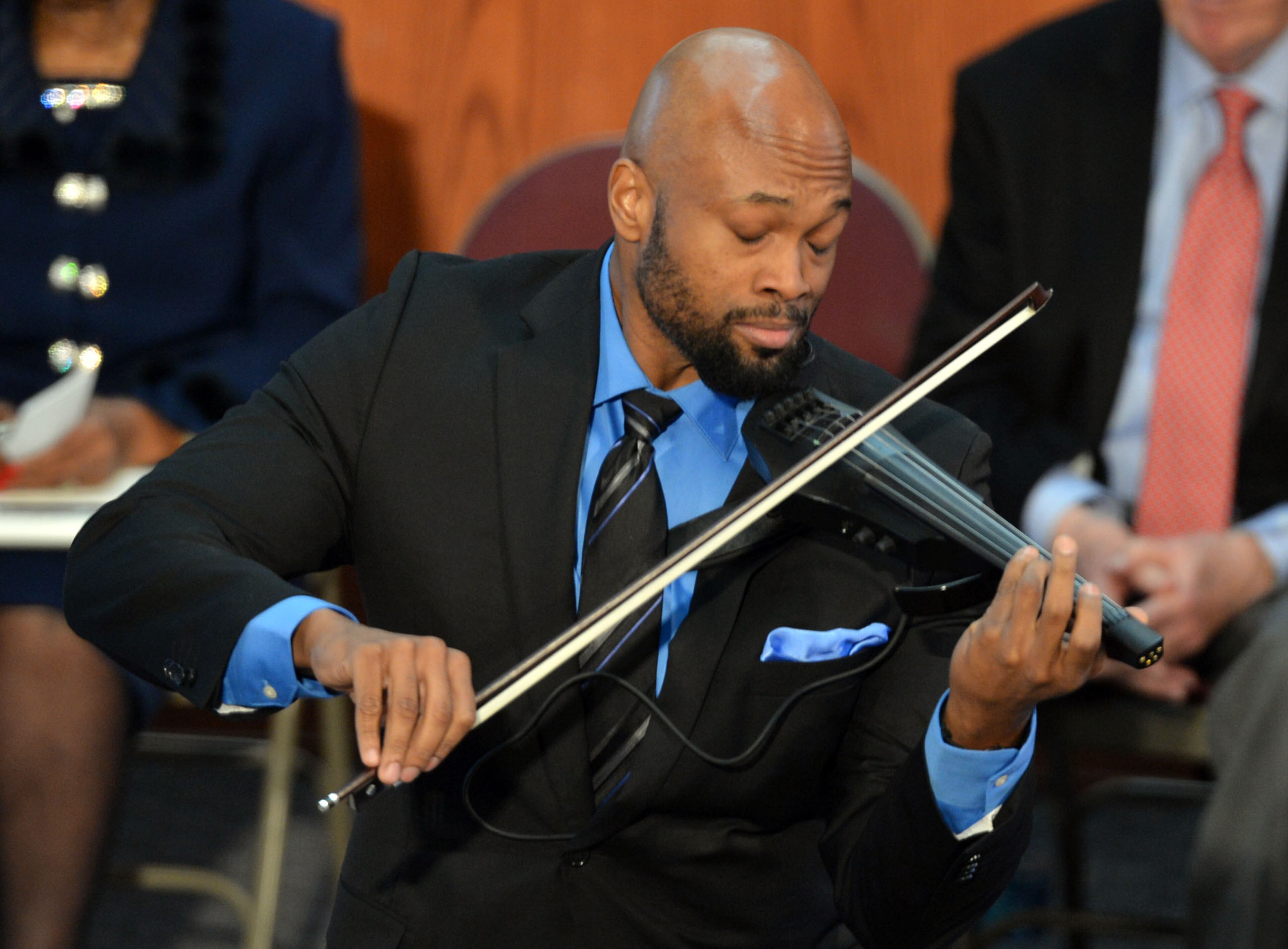 Violinist Ken Ford performs during the service.