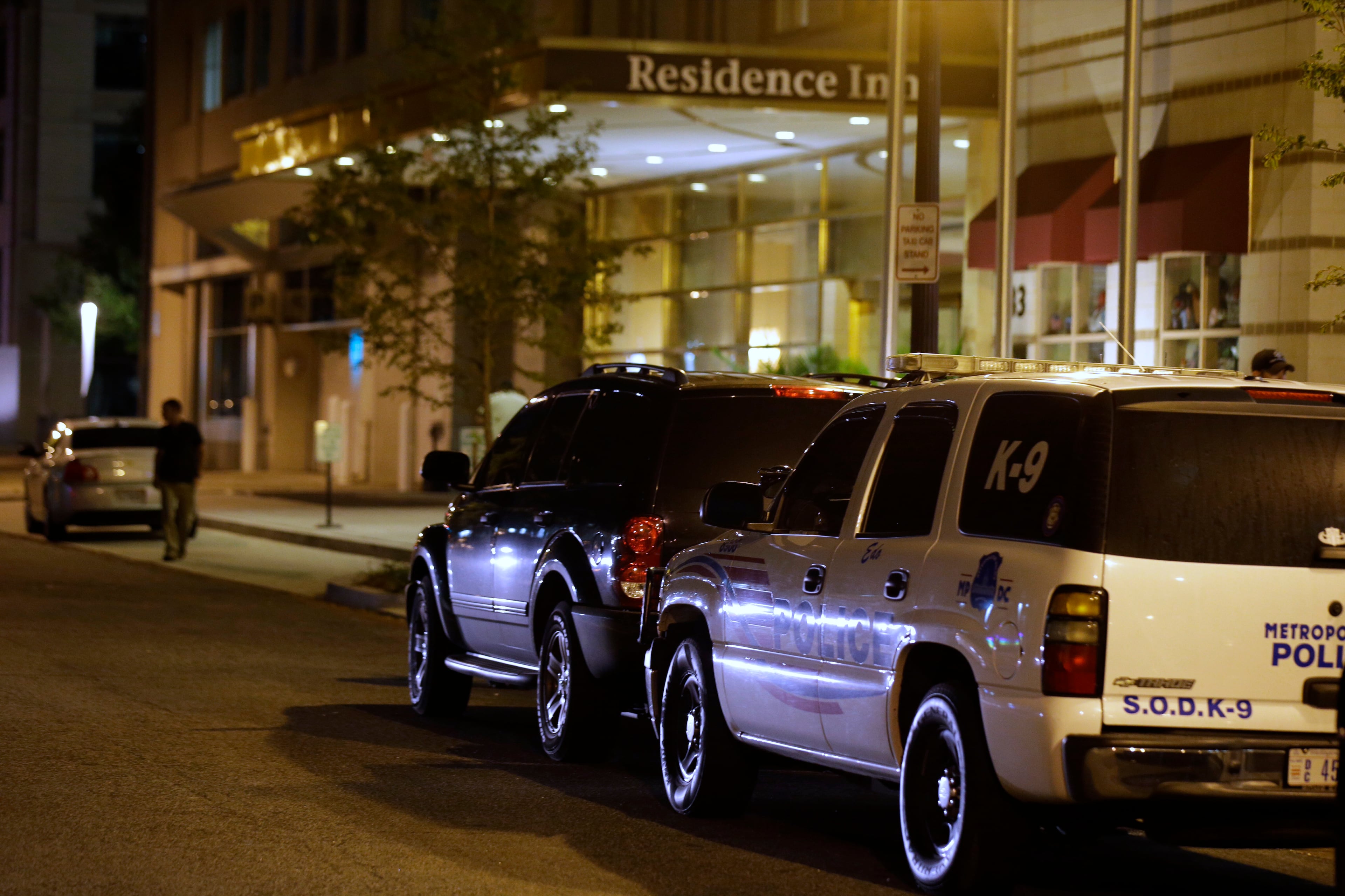 Police cars are parked outside a Residence Inn hotel where it is believed the gunman involved in the Washington Navy Yard shooting had been staying, Monday Sept. 16, 2013 in Washington. Aaron Alexis, a former Navy reservist went on a shooting rampage Monday inside a building at the heavily secured Washington Navy Yard, firing from a balcony onto office workers in an atrium below, authorities and witnesses said.(AP Photo/Alex Brandon)