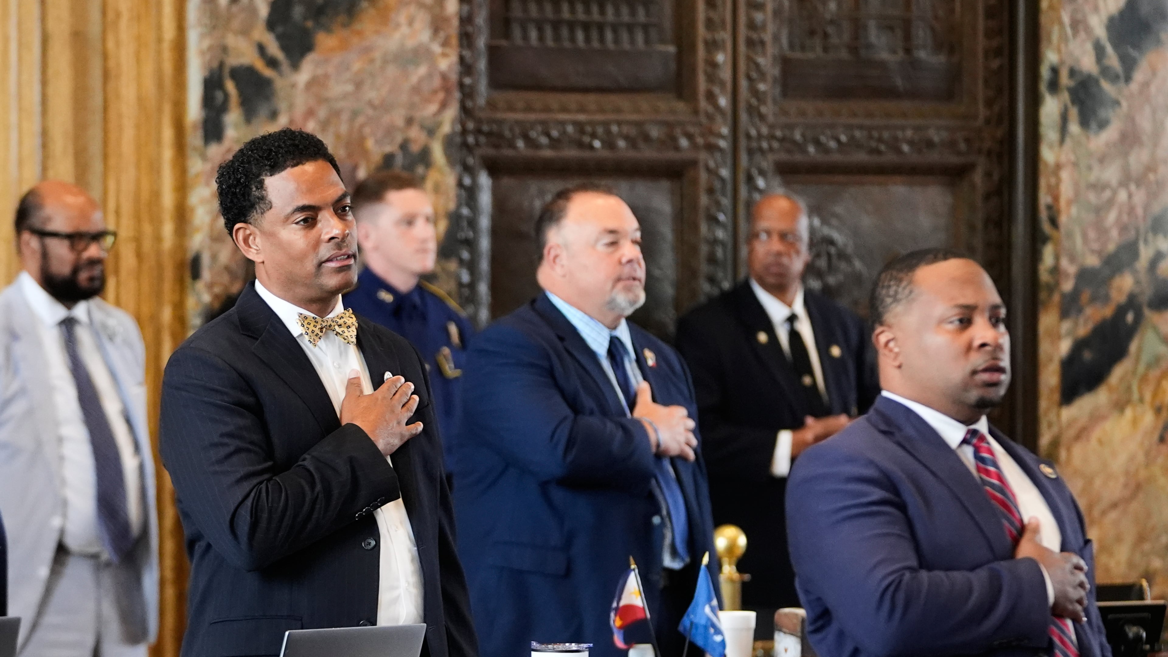 Louisiana Reps. Adrian Fisher, D-Dist 16, left, Chad Michael Boyer, R-Dist 46, and C. Travis Johnson, D-Dist 21, right, recite the pledge of allegiance prior to a house vote on a redistricting plan to eliminate a majority-Black congressional district in response to a U.S. Supreme Court ruling, in Baton Rouge, La., Thursday, May 21, 2026. (AP Photo/Gerald Herbert)