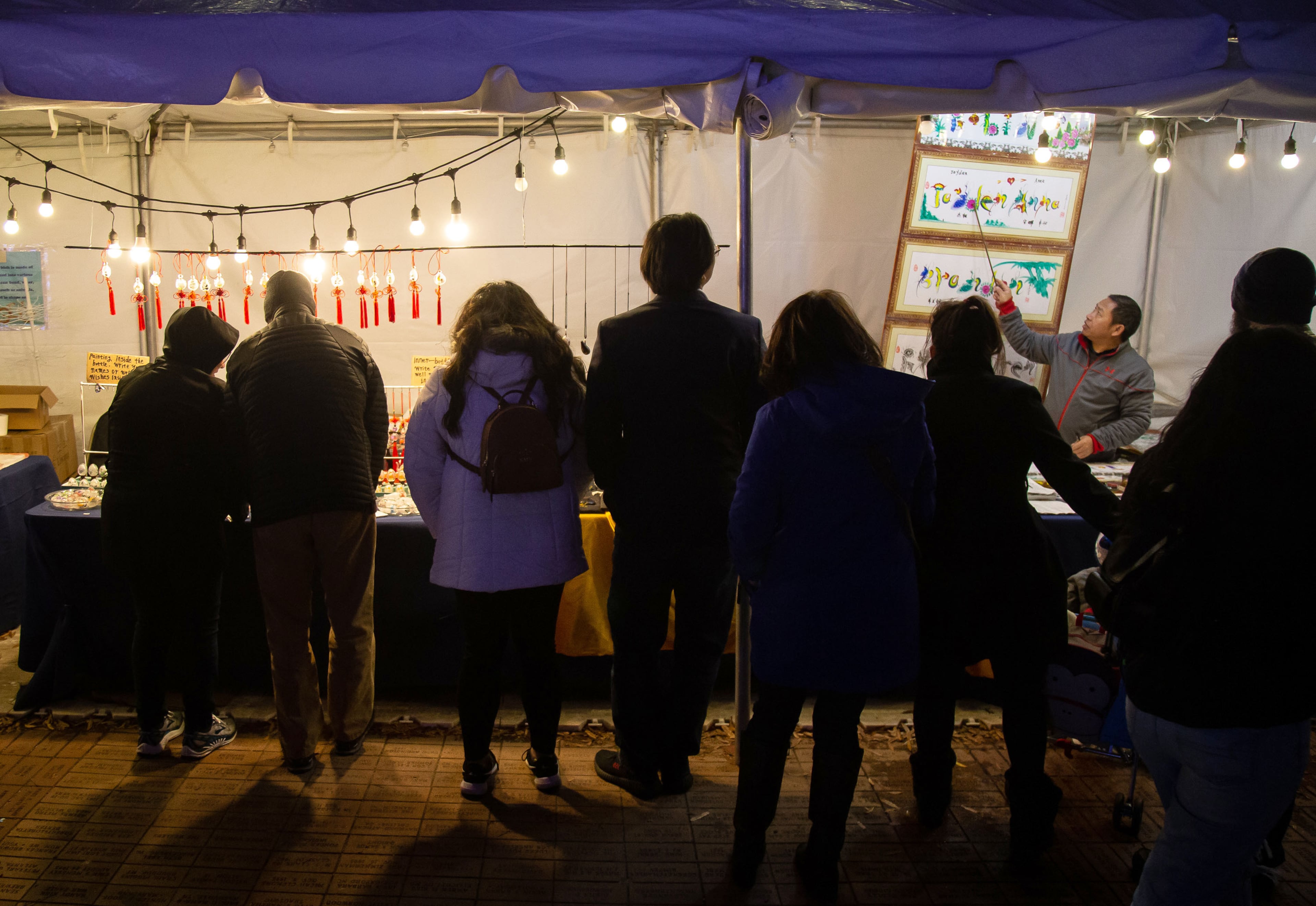 Fairgoers crowd around the artist tent during the Chinese Lantern Festival at Centennial Olympic Park Saturday, January 04, 2020. STEVE SCHAEFER / SPECIAL TO THE AJC