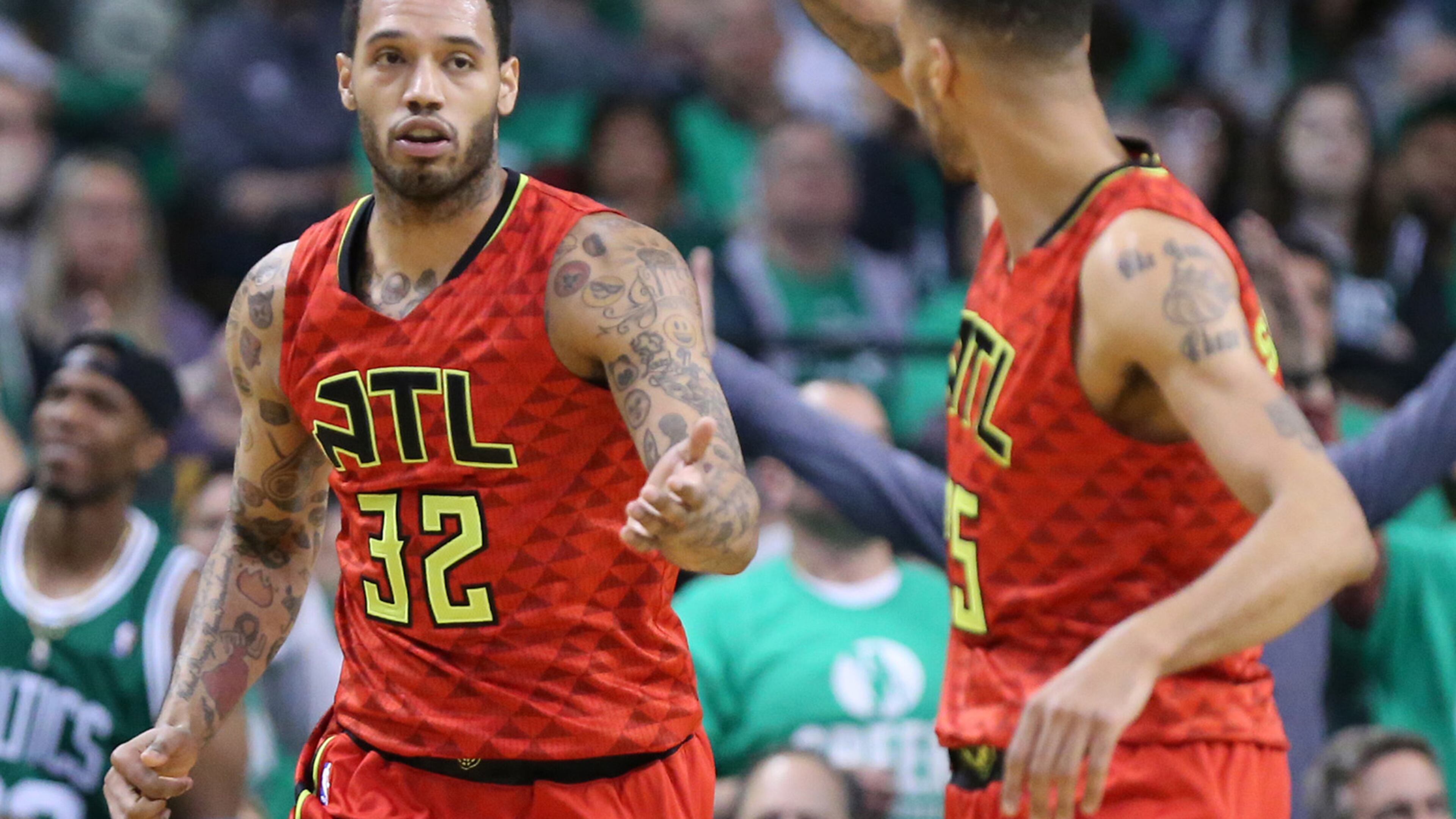 Mike Scott of the Hawks (left) gets five from Thabo Sefolosha during Game 6 of an NBA basketball first-round playoff series at TD Garden on Thursday, April 28, 2016, in Boston. Curtis Compton / ccompton@ajc.com