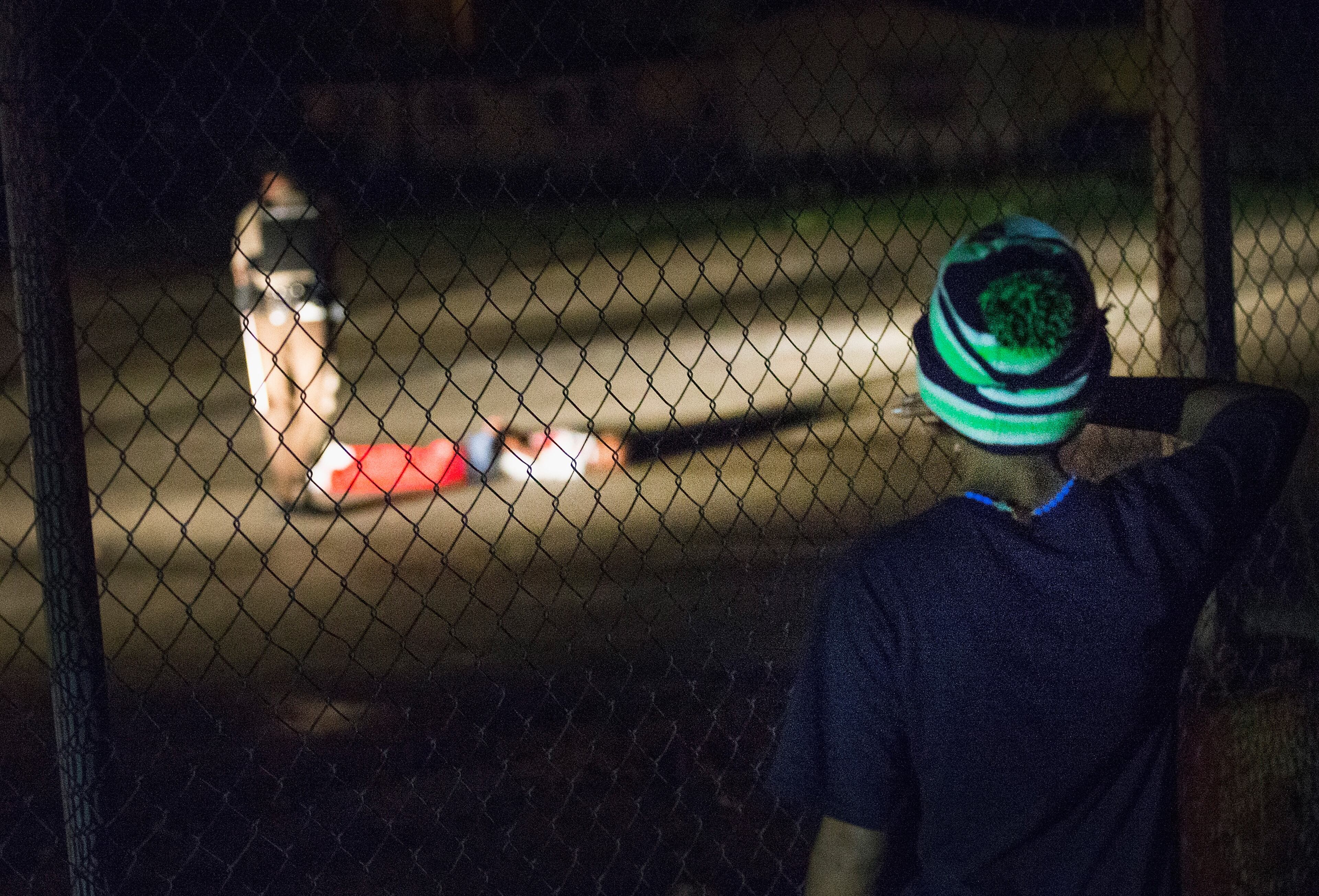 FERGUSON, MO - AUGUST 09: A young boy looks at a man lying in a parking lot with what appears to be gunshot wounds after a barrage of gun fire erupted along West Florrisant Street during a demonstration to mark the 1-year anniversary of the shooting of Michael Brown on August 9, 2015 in Ferguson, Missouri. Brown was shot and killed by a Ferguson police officer on August 9, 2014. His death sparked months of sometimes violent protests in Ferguson and drew nationwide focus on police treatment of black offenders. (Photo by Scott Olson/Getty Images)