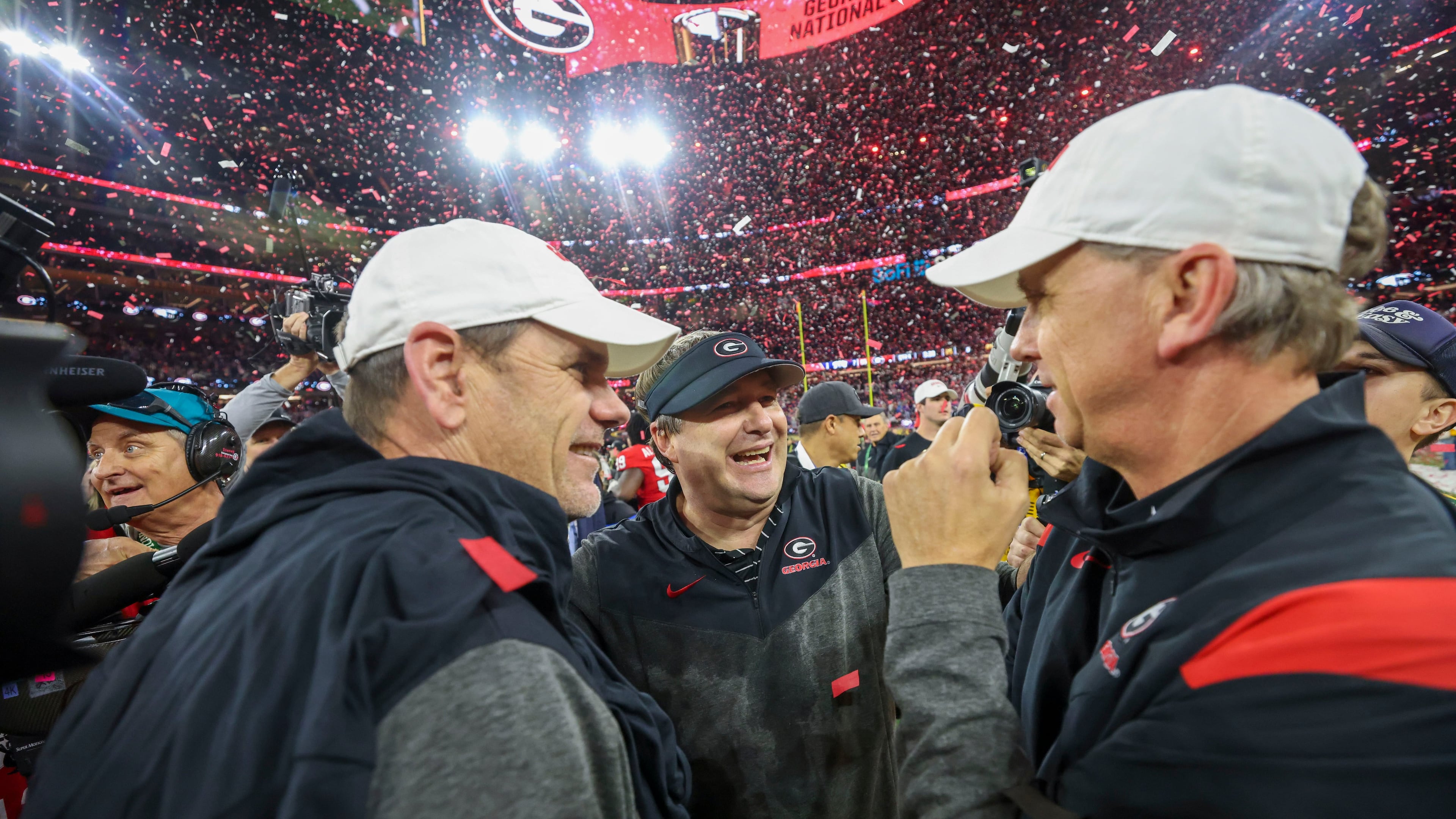 Georgia head coach Kirby Smart (center) celebrates with assistant coaches Mike Bobo (left) and Todd Monken after their win against TCU in the 2023 College Football Playoff National Championship at SoFi Stadium, in Inglewood, Calif. Georgia won 65-7. (Jason Getz /AJC)