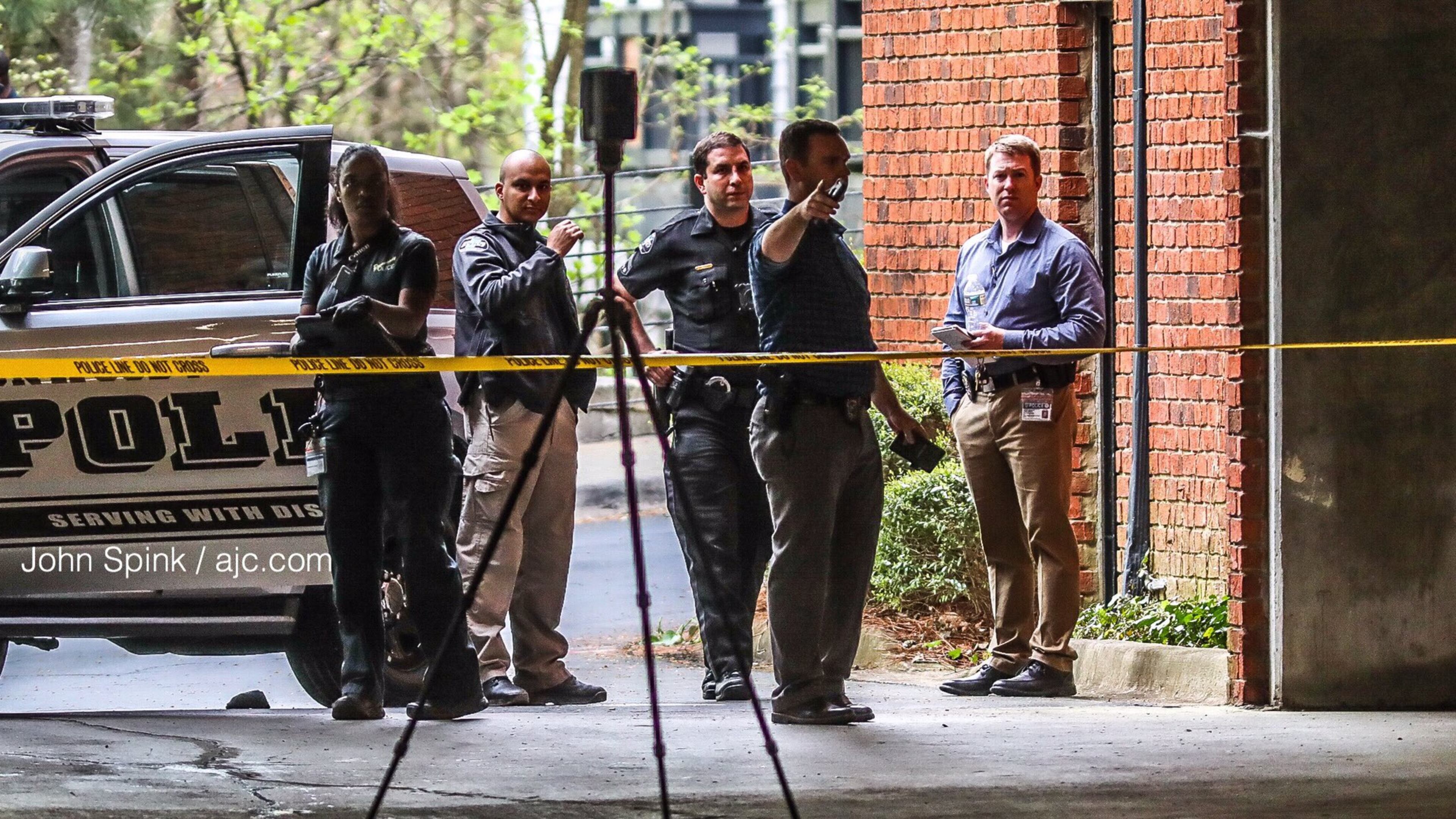 Investigators collect evidence at the scene of a homicide Monday morning at a Dunwoody apartment complex near Perimeter Mall.