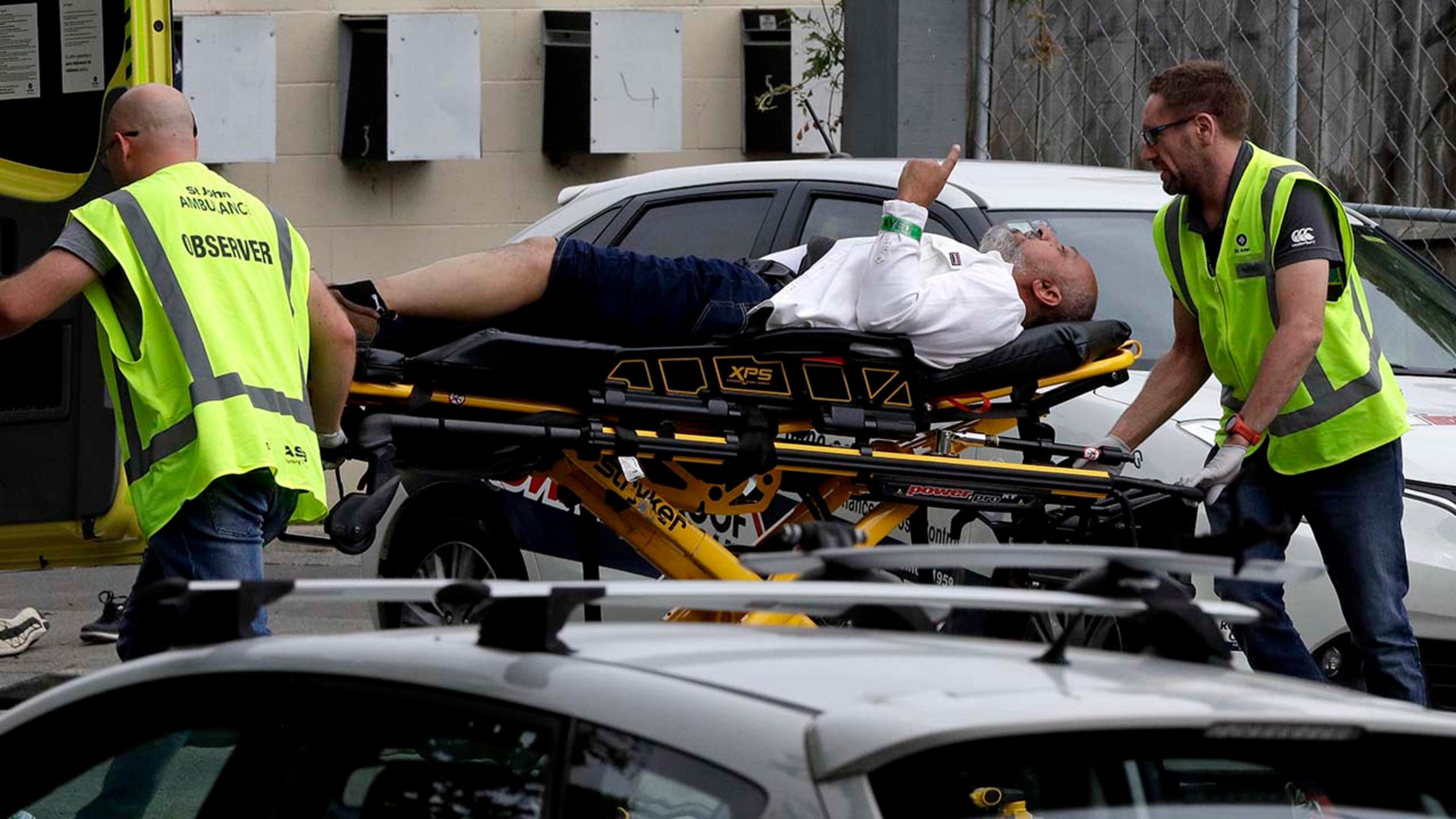 Ambulance staff take a man from outside a mosque in central Christchurch, New Zealand, Friday, March 15, 2019. A witness says many people have been killed in a mass shooting at a mosque in the New Zealand city of Christchurch.