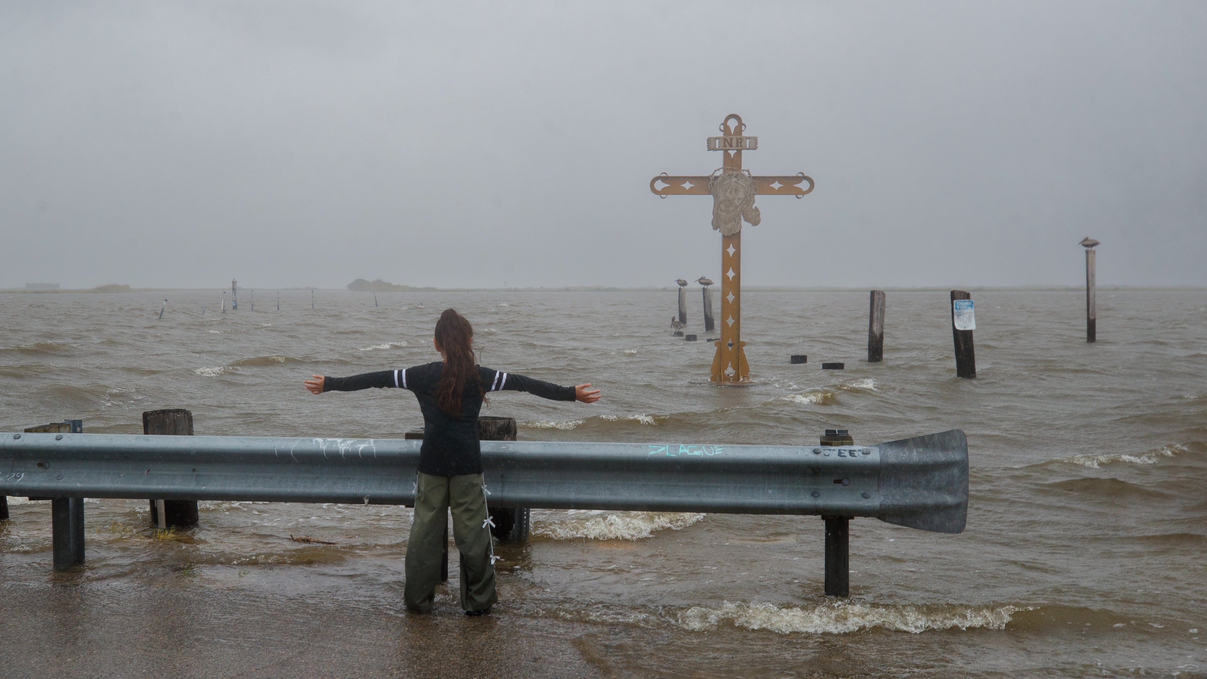 Grettel Badillo catches the wind from Tropical Storm Bertha at the Hurricane Katrina Memorial in Shell Beach, La., Wednesday, July 22, 2026. (David Grunfeld/The Times-Picayune/The New Orleans Advocate via AP)